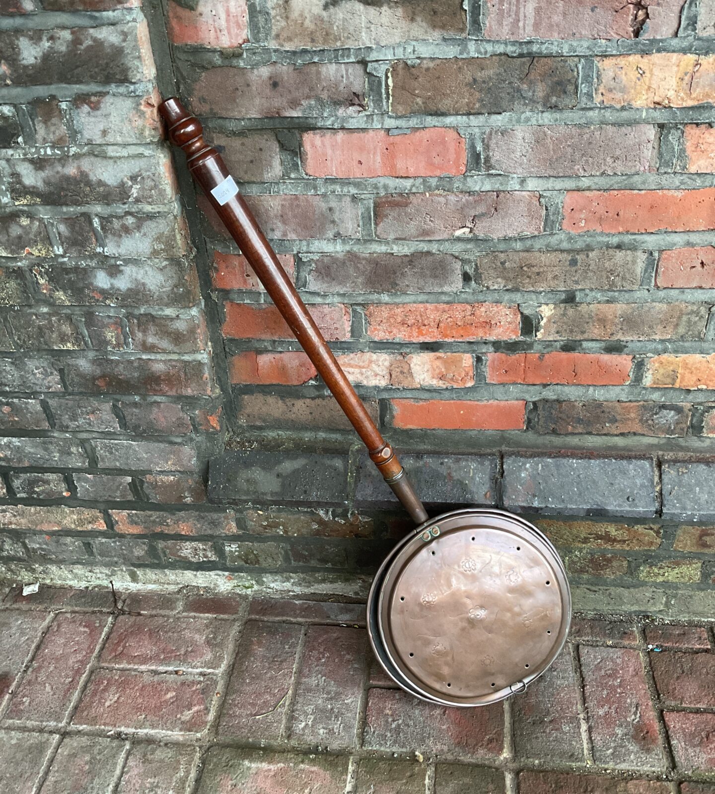 Vintage copper bed warmer with flower pattern