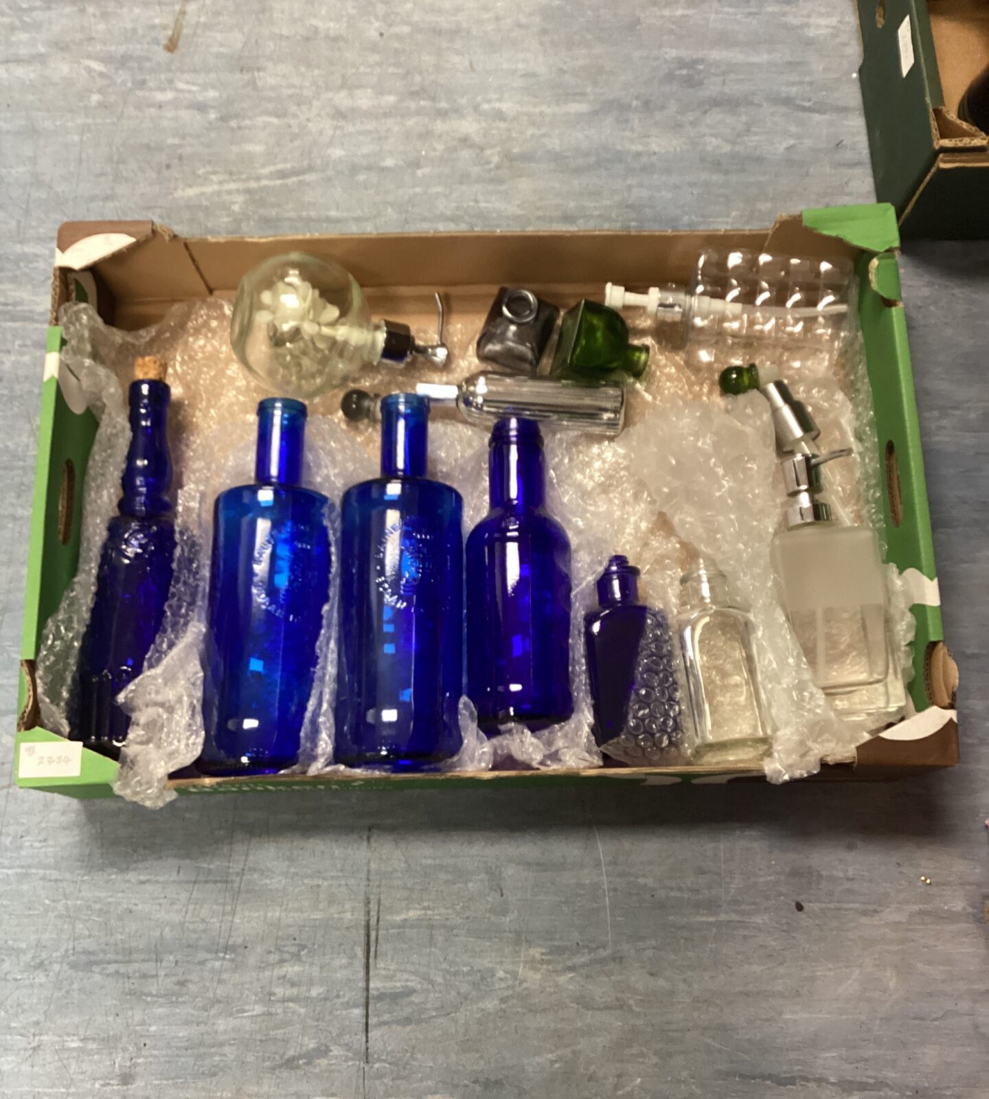 Box of vintage coloured bottles