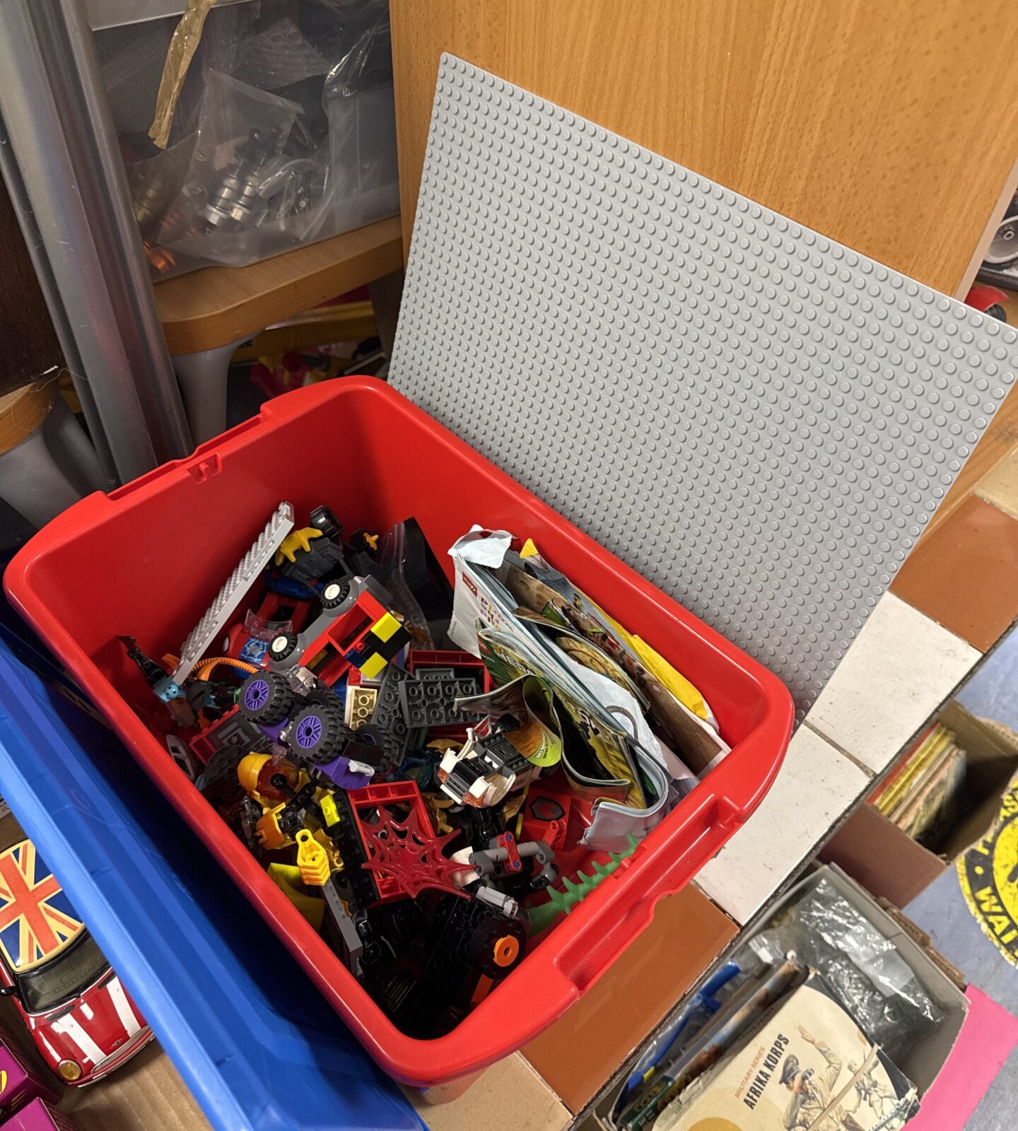 Box of Lego with some manuals and a board