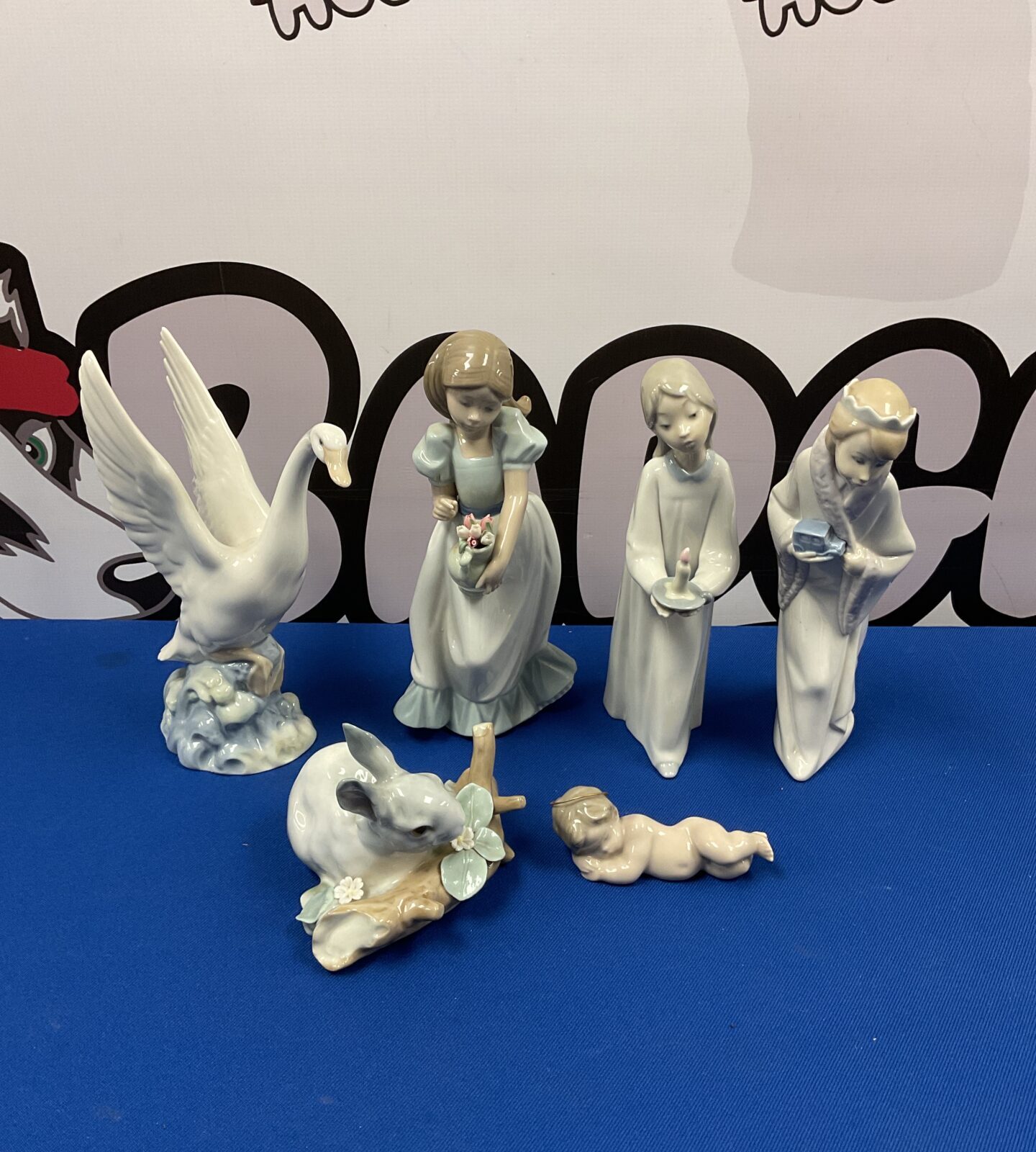 Six lladro & nao porcelain ornaments including cherub & swan