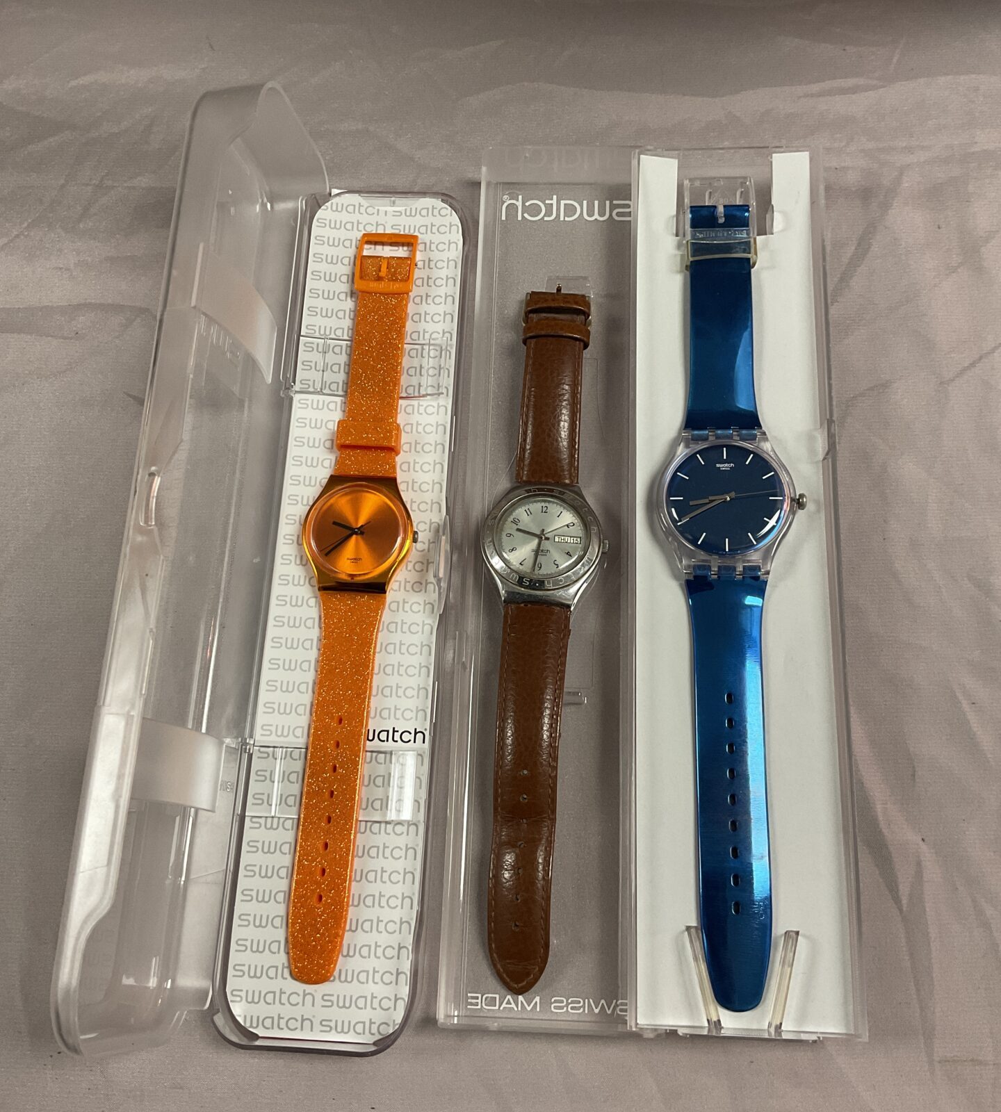 Three swatch watches