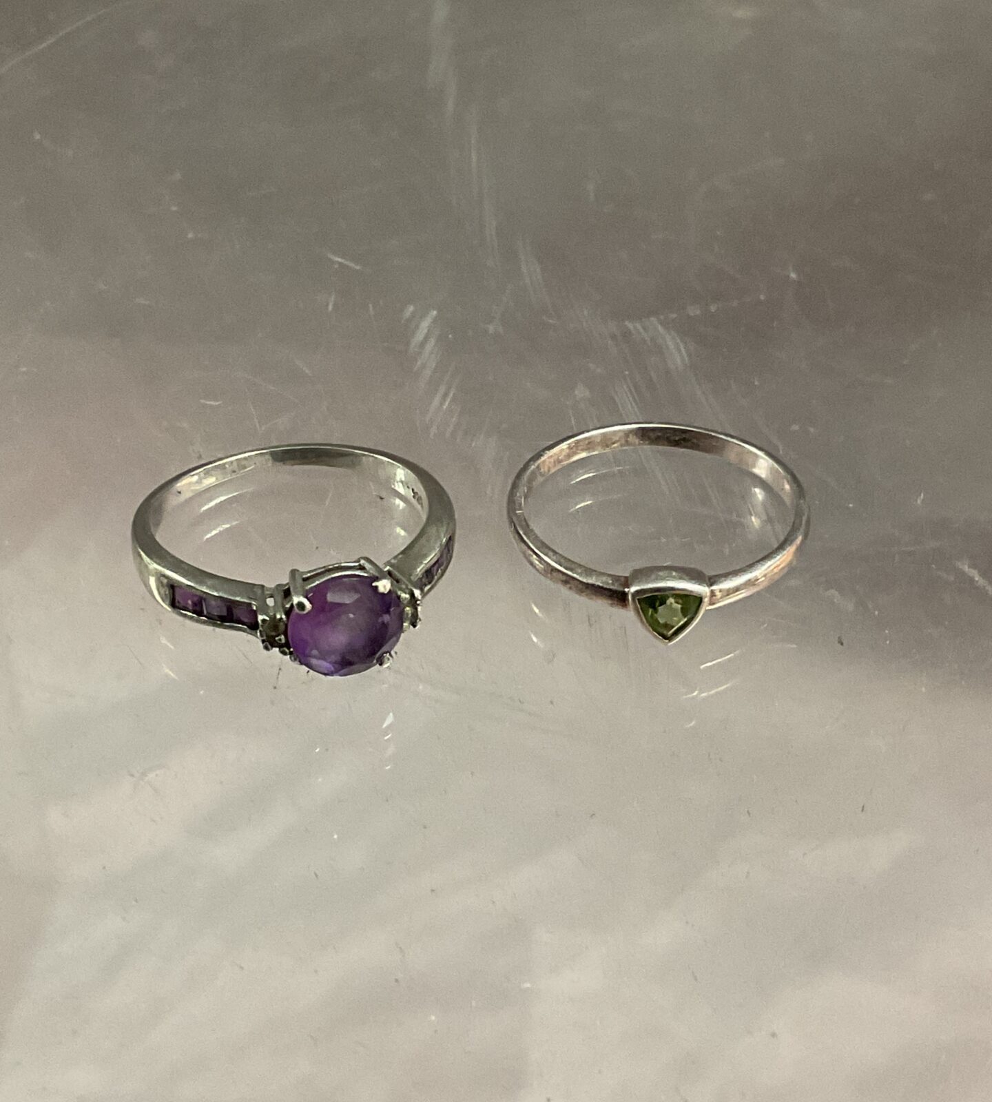 Two 925 Silver rings One set peridot and one set amethyst stones sizes O P