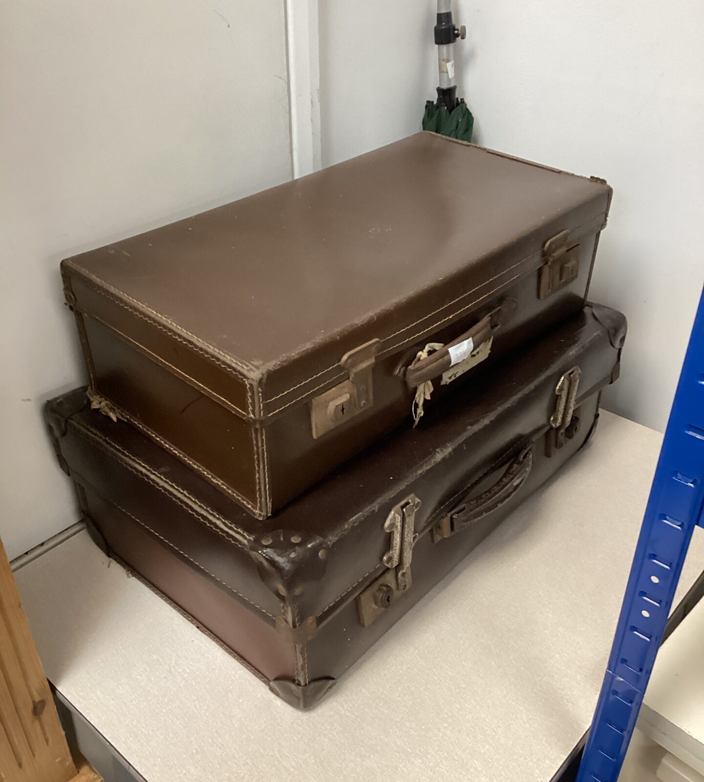 Two vintage brown leather suitcases