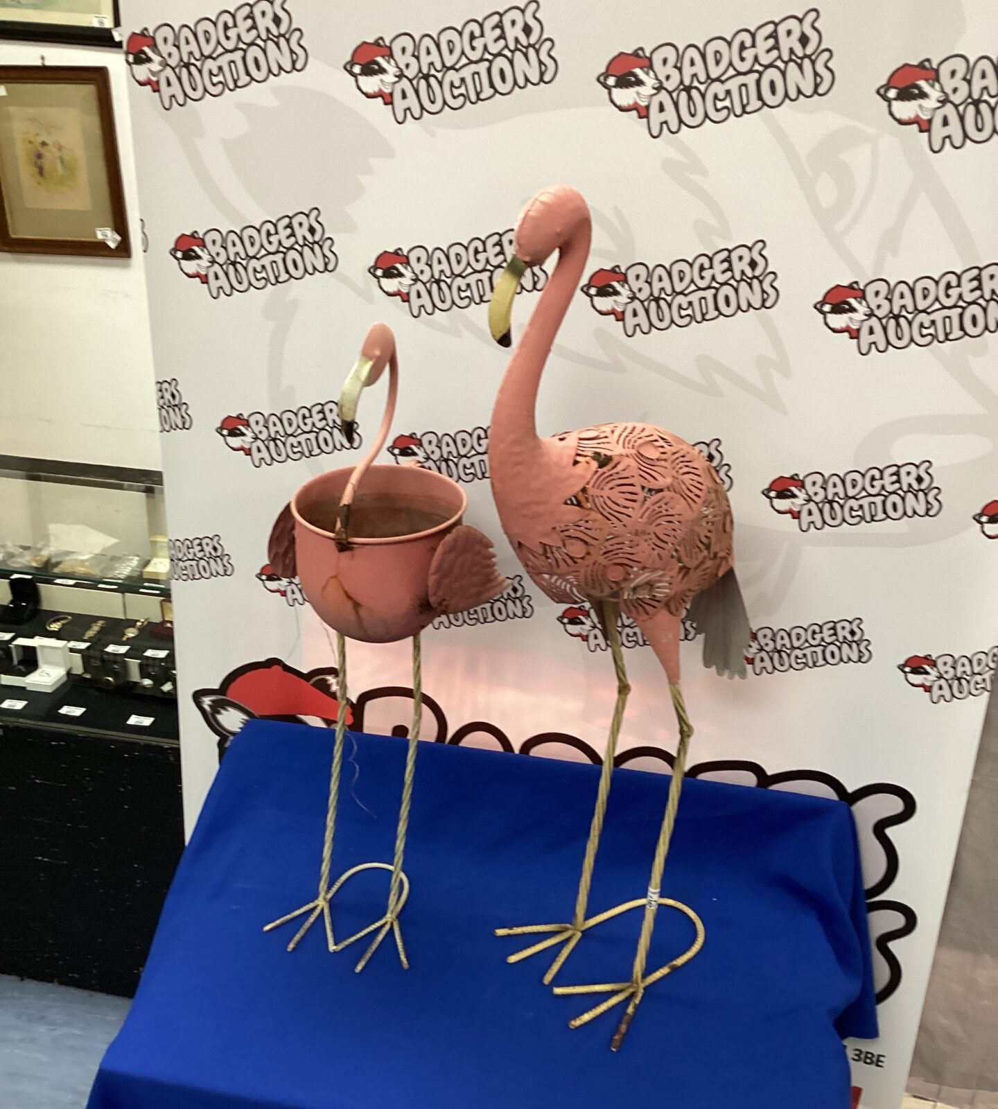 Two metal flamingo garden ornaments