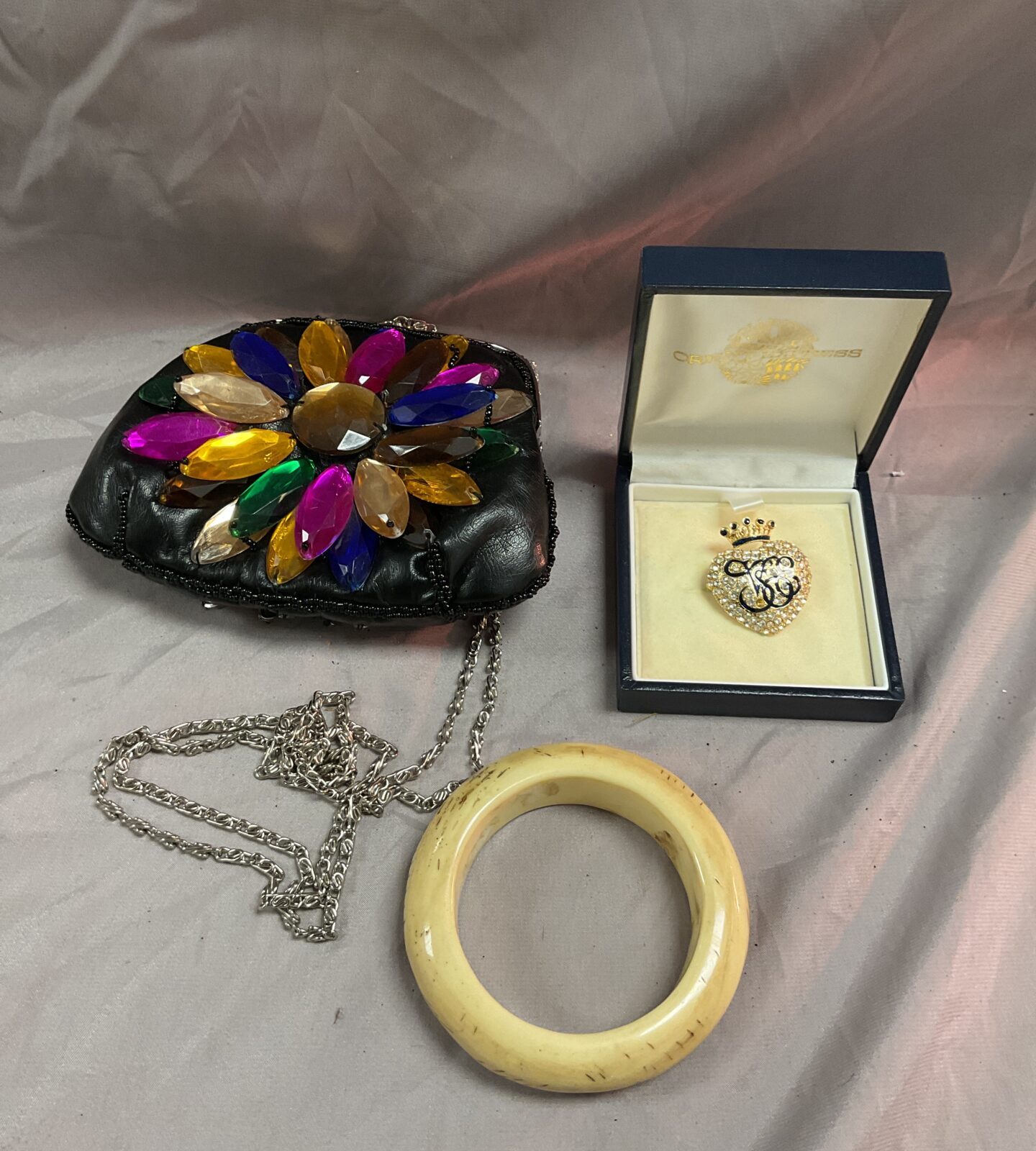 Butler and Wilson handbag , bone bangle and orient express brooch