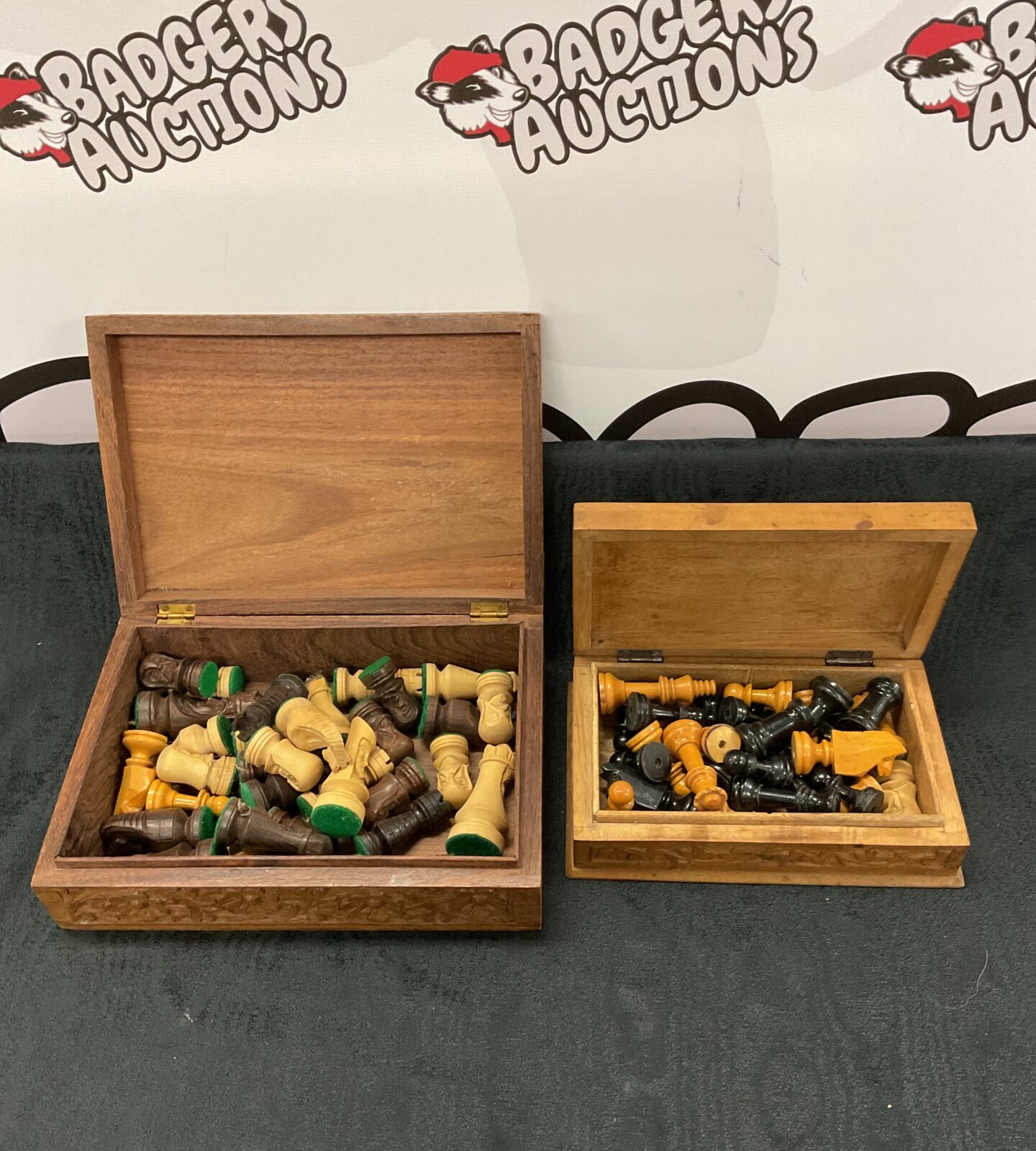 Two carved indian wooden boxes with chess pieces