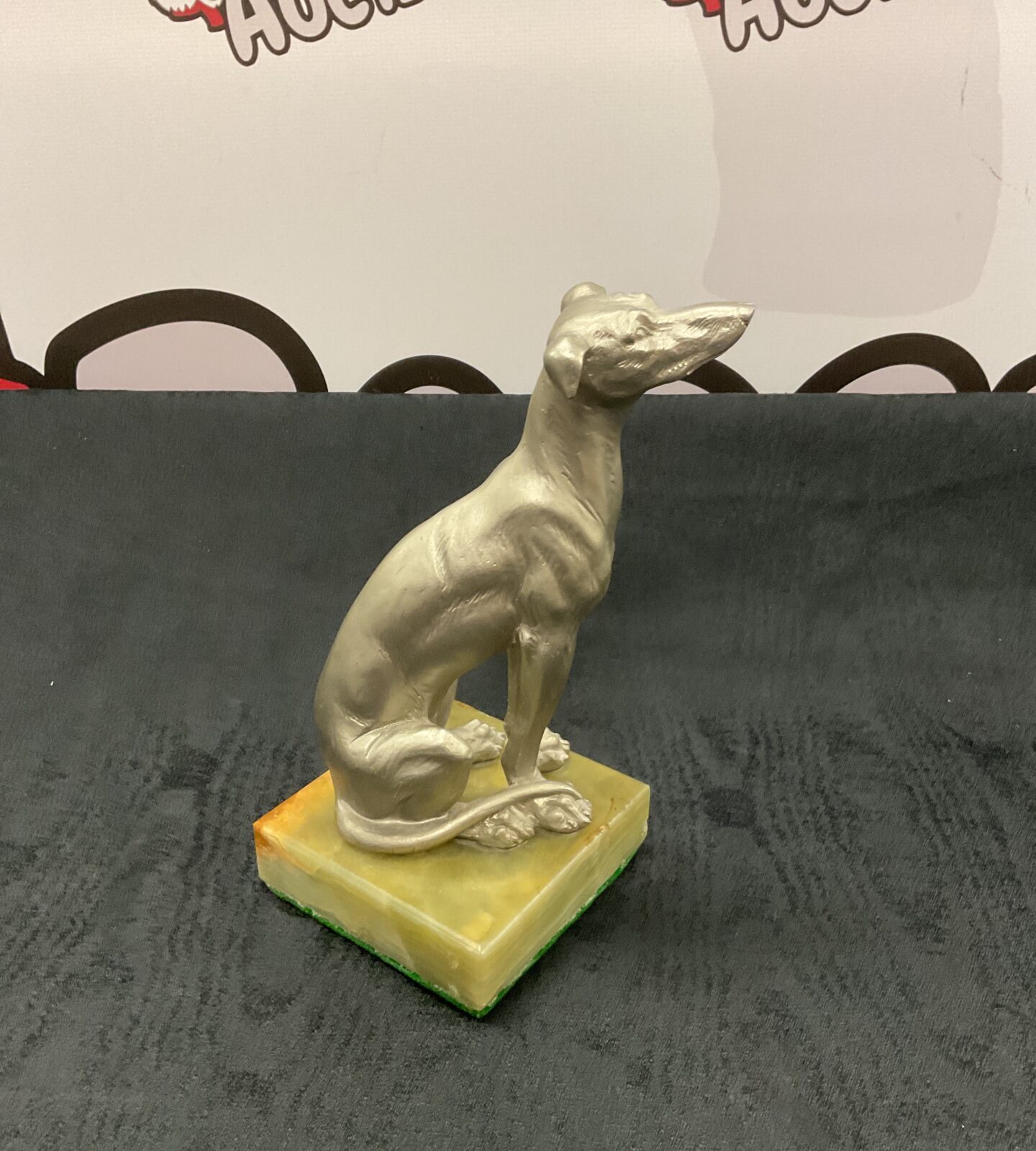 silvered composite greyhound on onyx stand