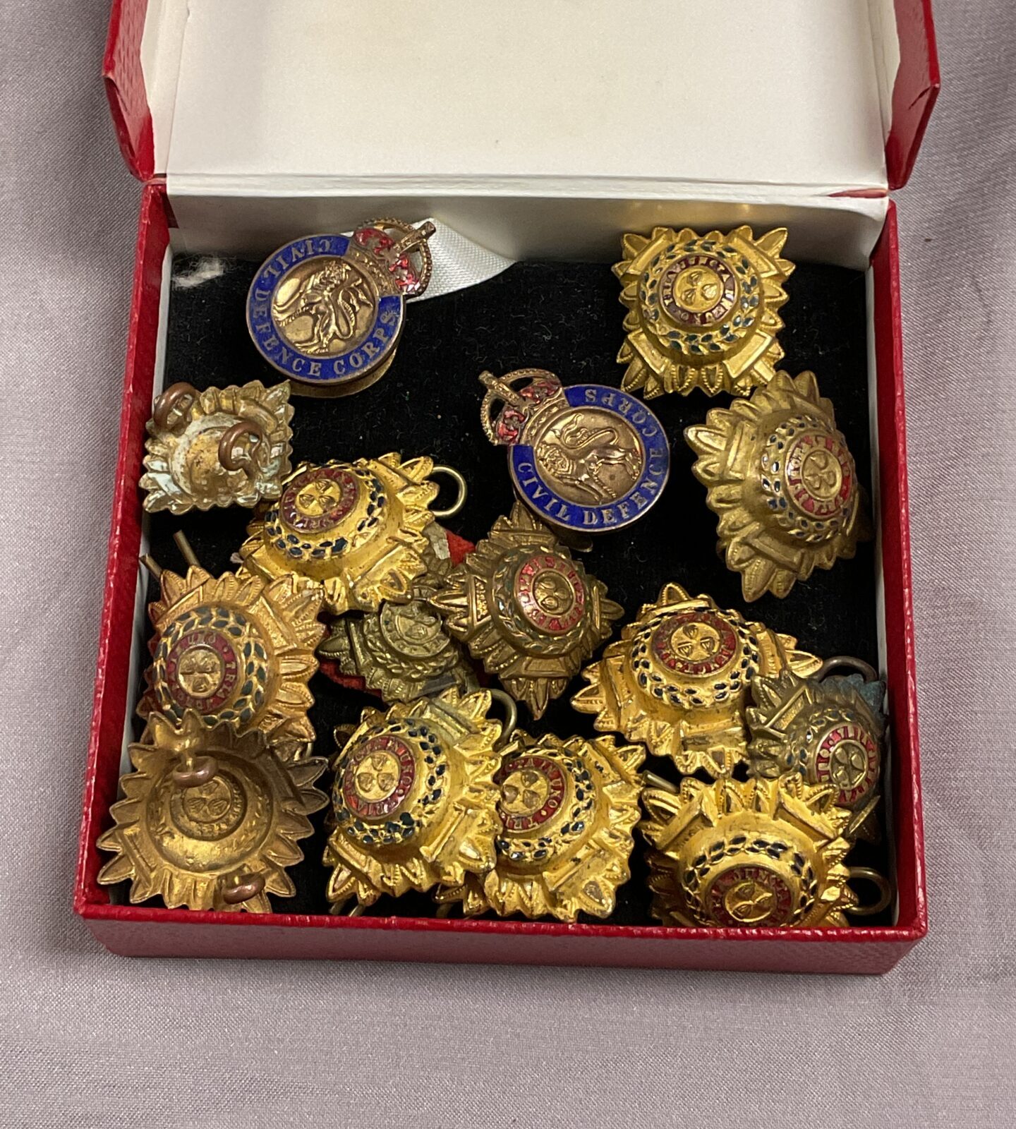 quantity of British army rank pips and two civil defence badges