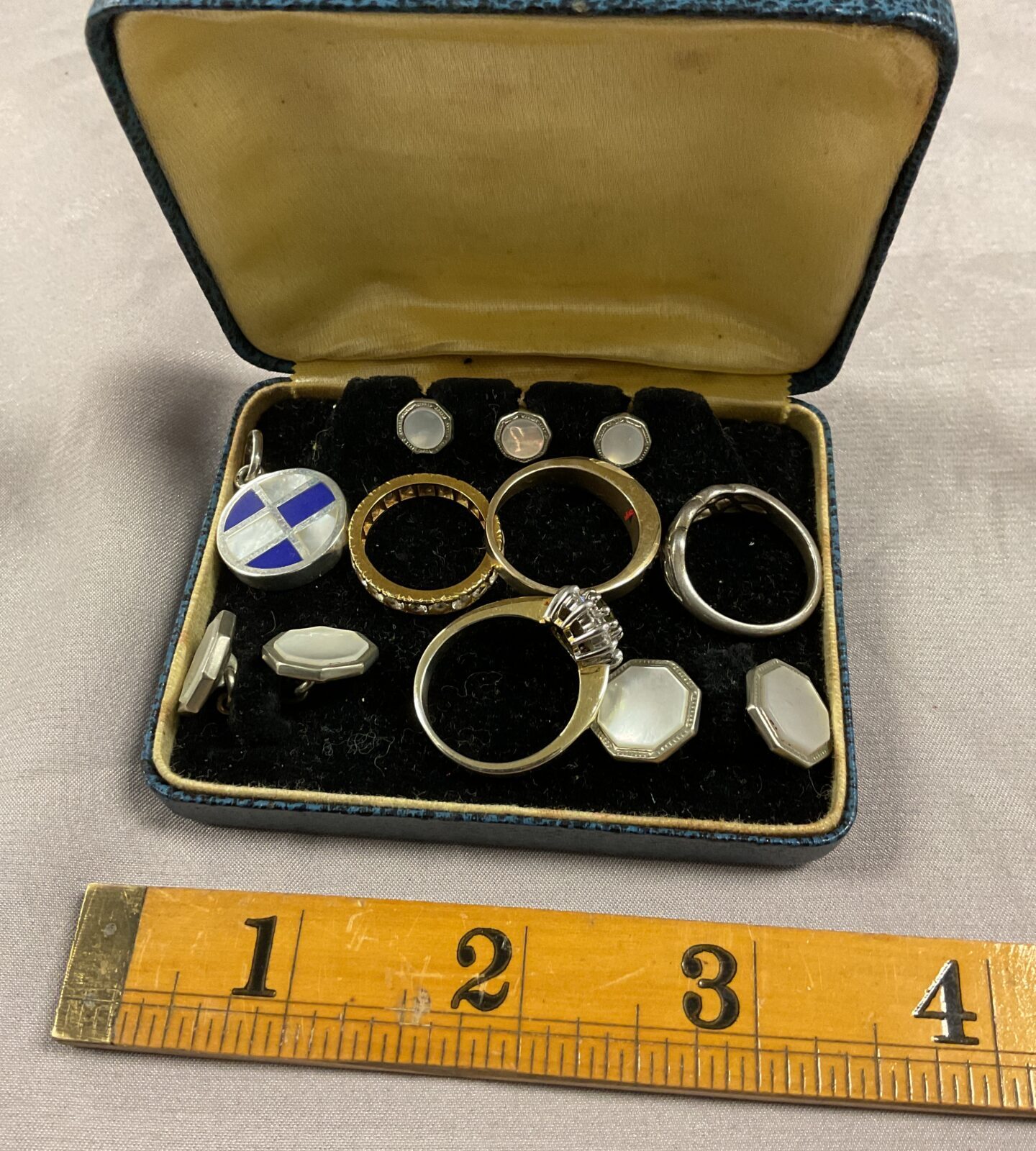 Box of mother of pearl cufflinks and collar studs four rings and a pendant