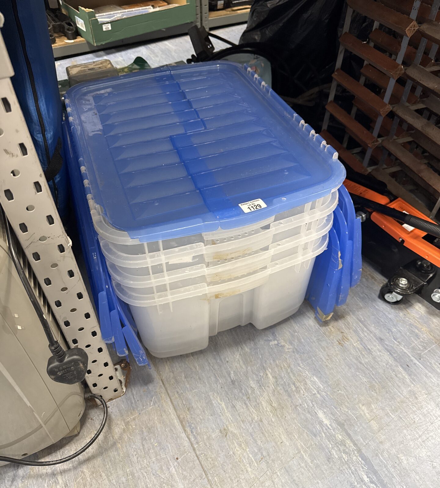 Four stackable plastic storage boxes