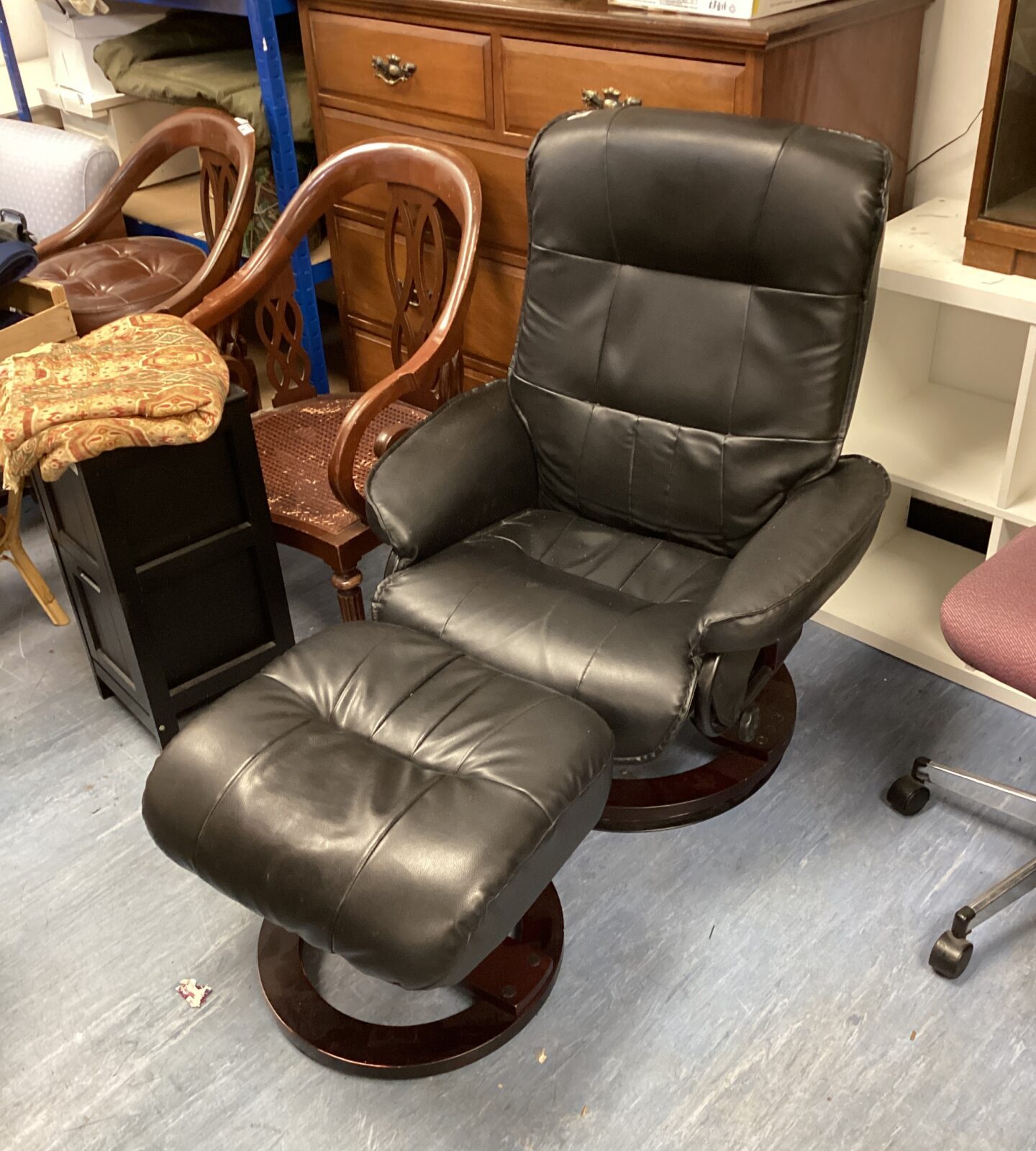 Black leather swivel chair with footrest