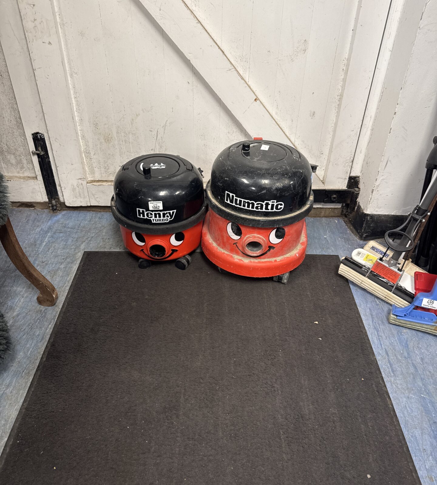 Two Henry hoover bodies only - one on left working, one on right spares/repairs plugged in inoperative