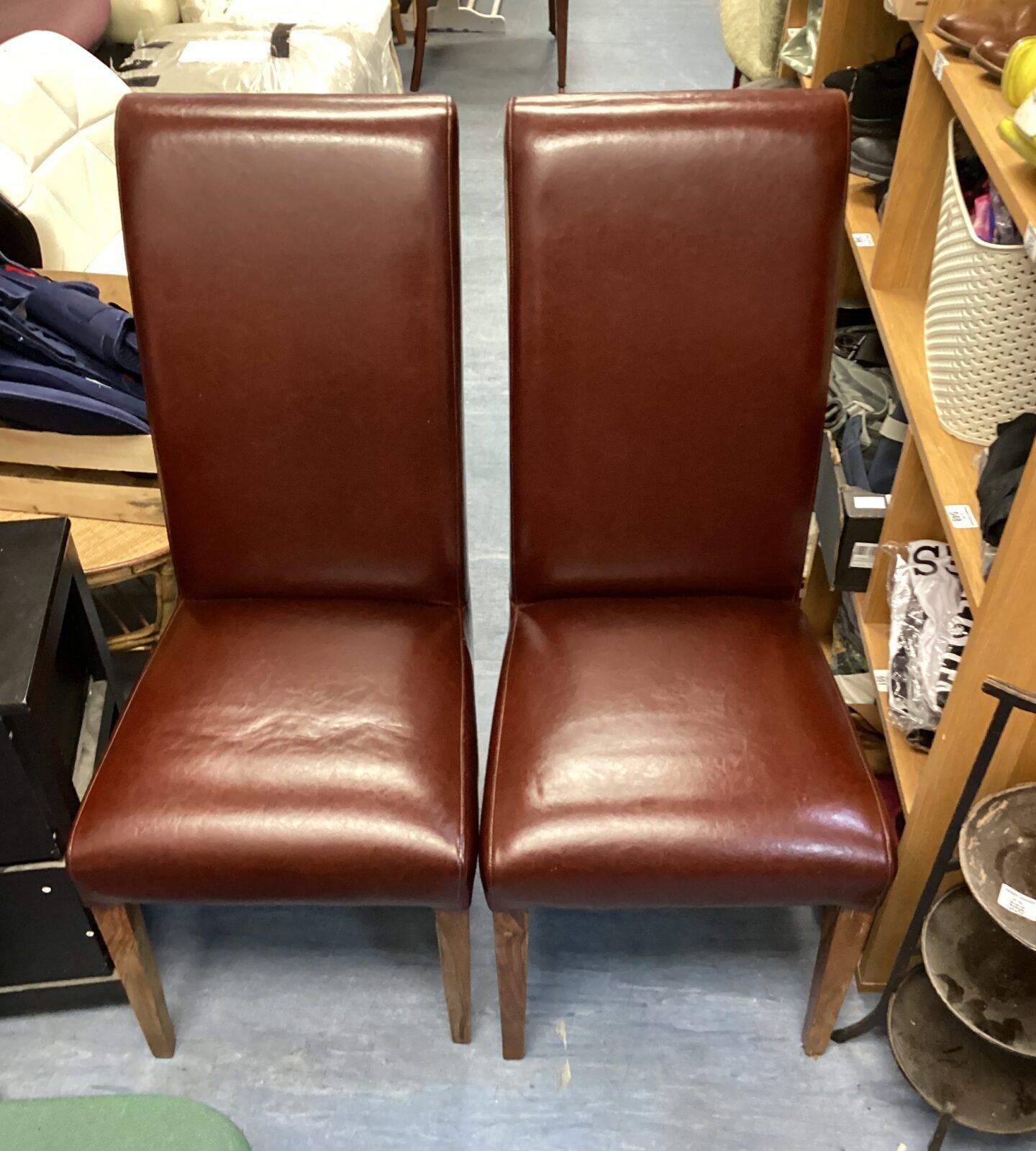 Two brown leather dining chairs