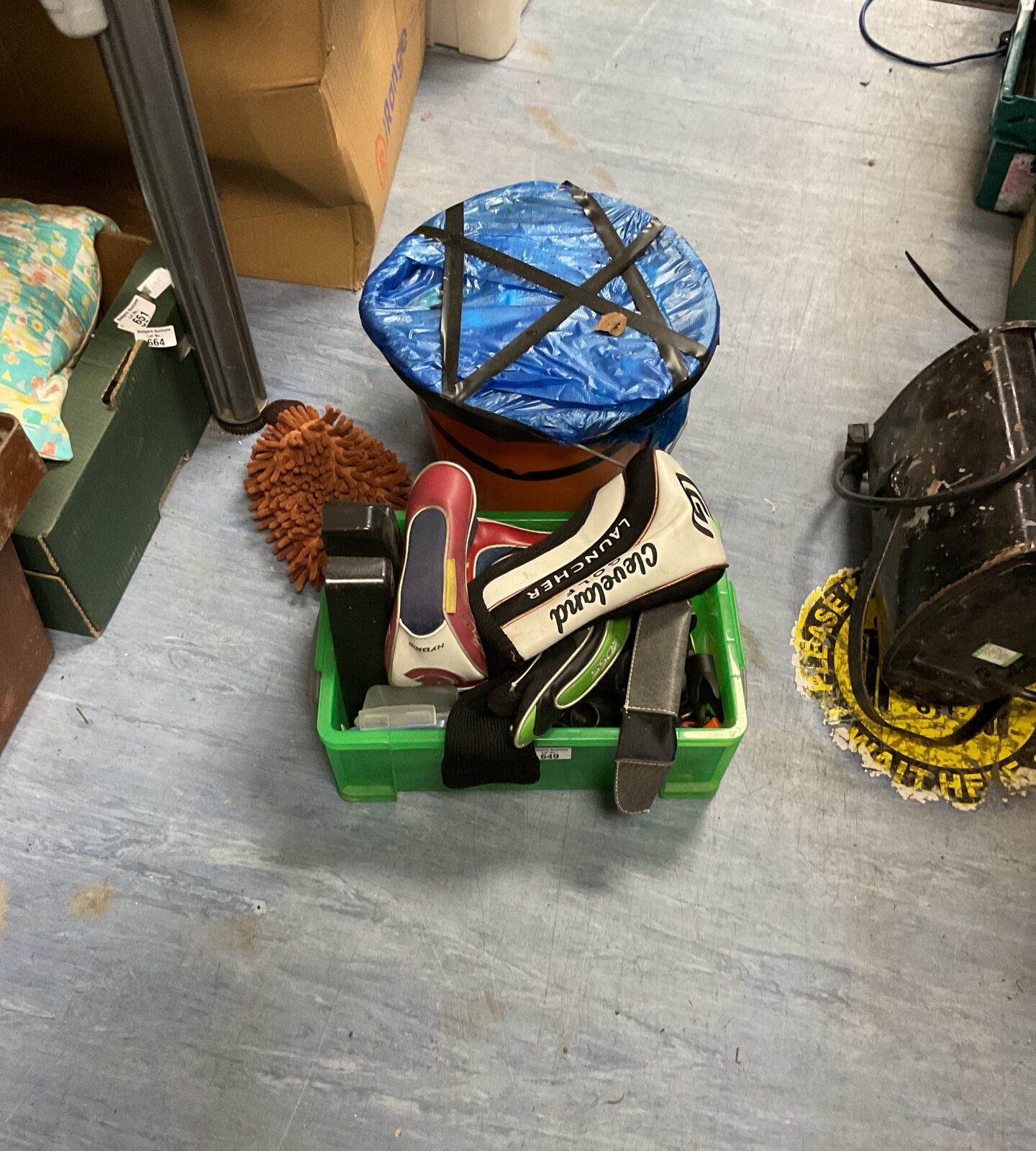 Box of golf club covers and bucket of golf balls