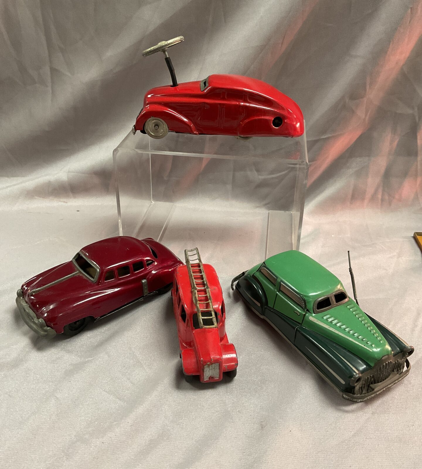 Three vintage tin cars two clockwork and dinky 250 fire engine