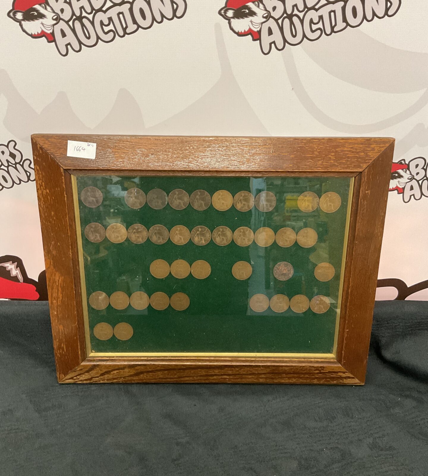 Collection of framed pennies dated 1900 to 1949