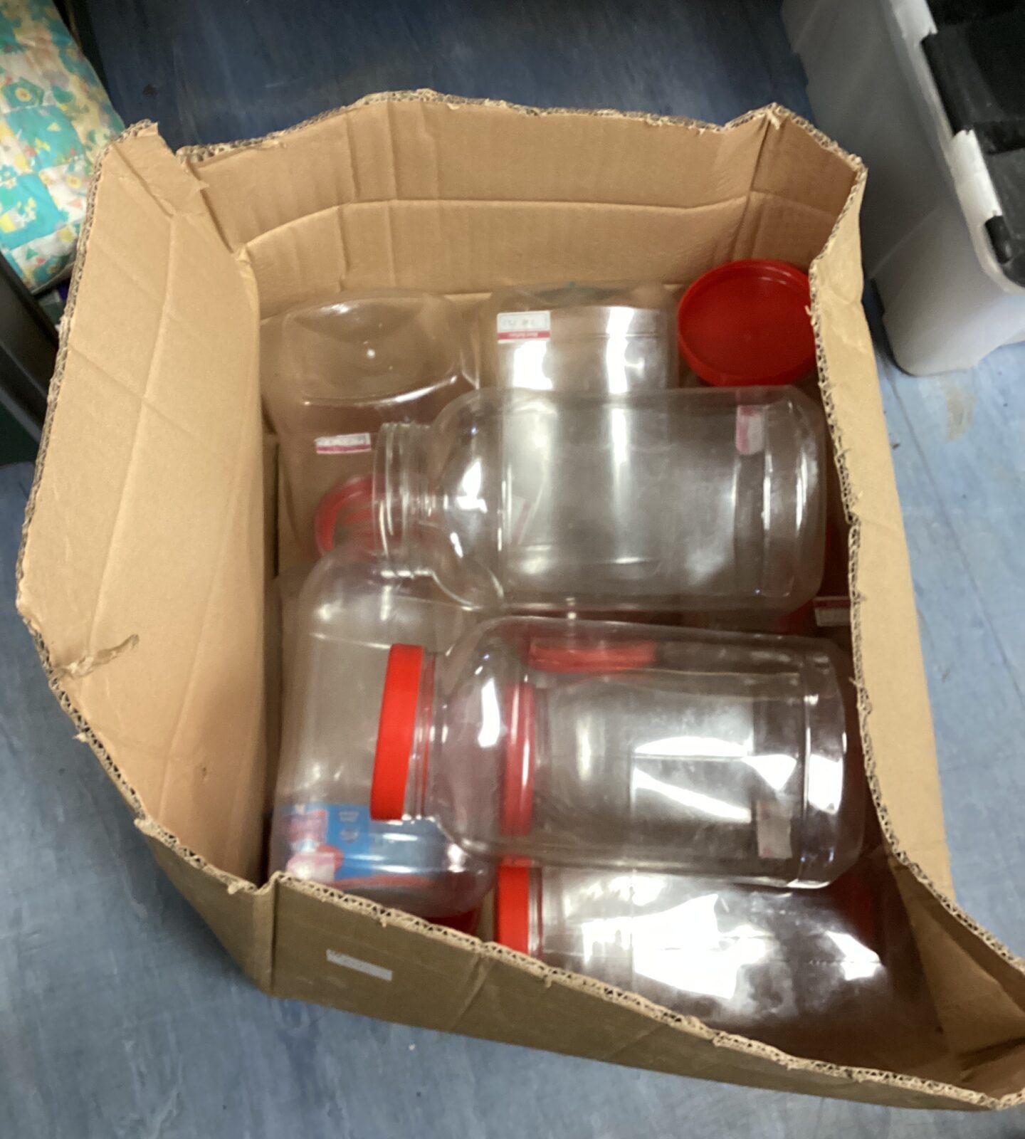 Box of large plastic sweet jars