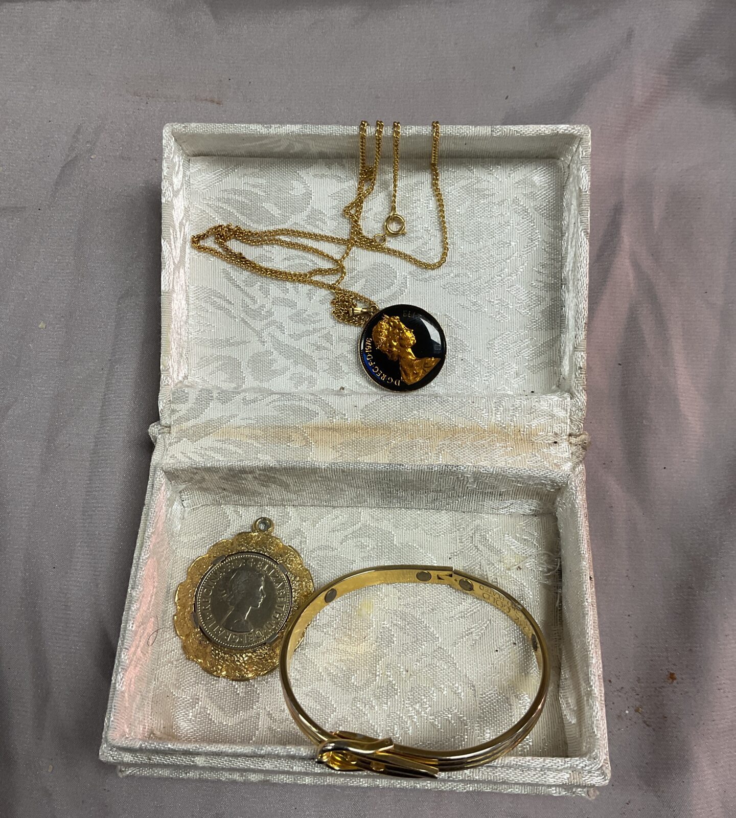 Two  coin pendants and 24k gold plate bracelet