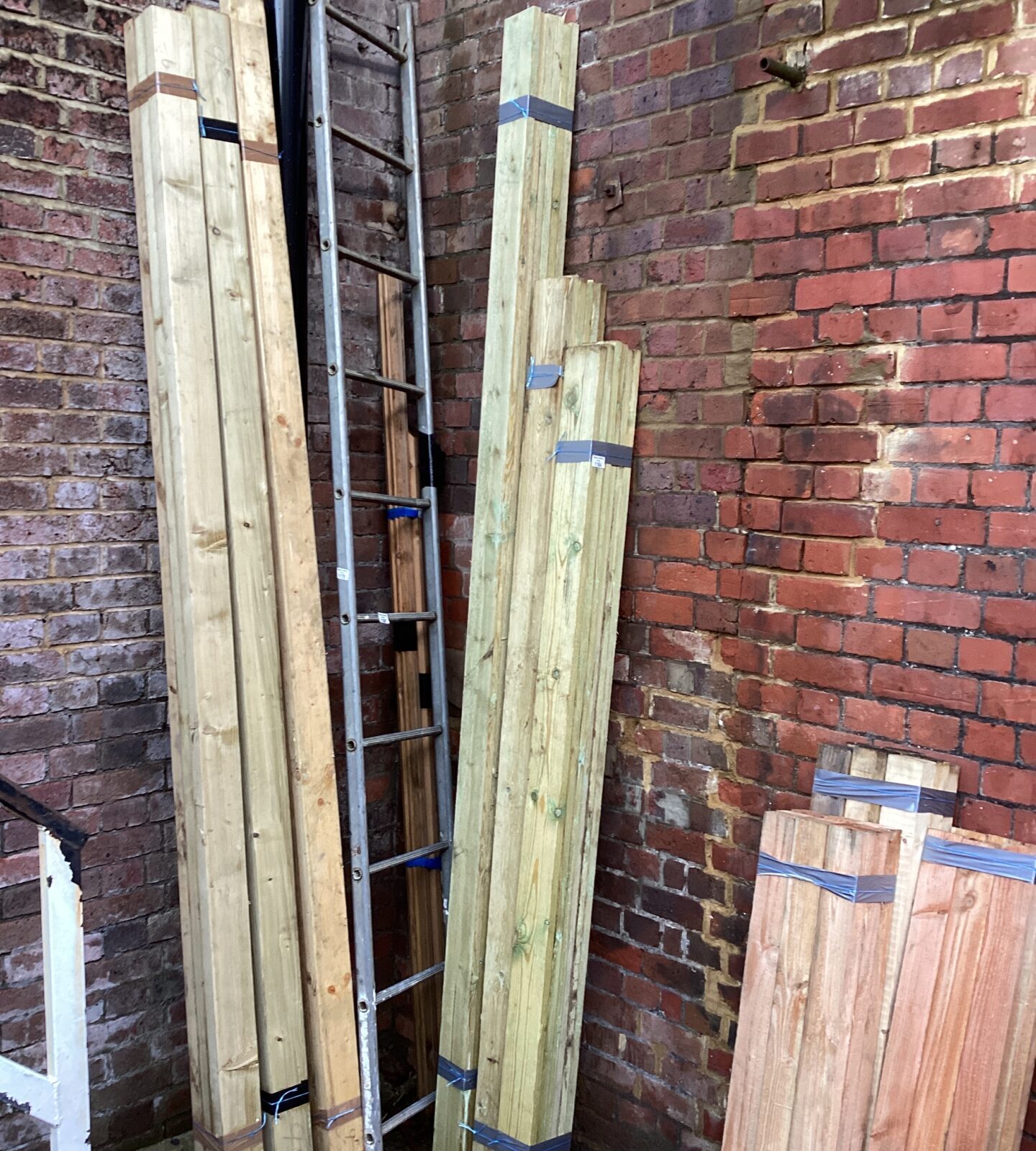 Three bundles of mixed lengths of timber