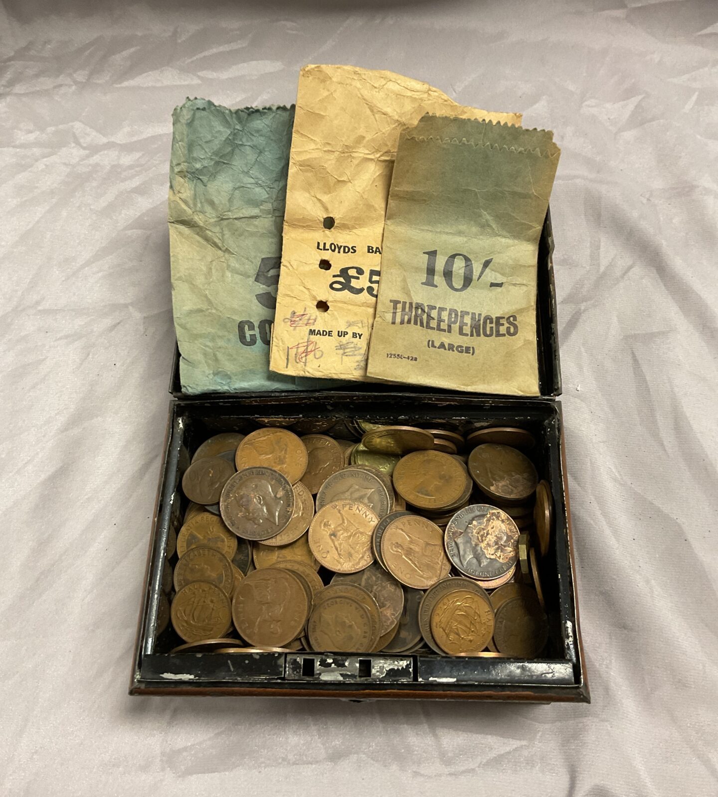 Money tin of assorted copper coins