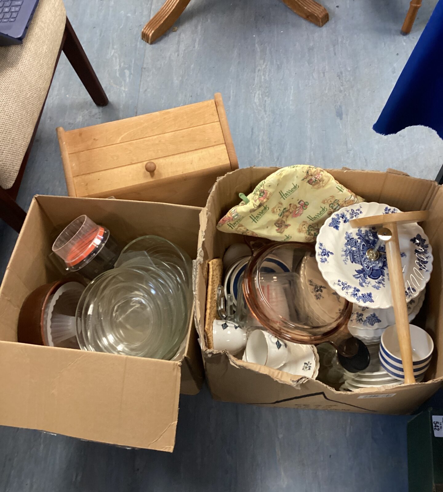 Two boxes of mixed kitchenware inc baking moulds, bread bin & plates