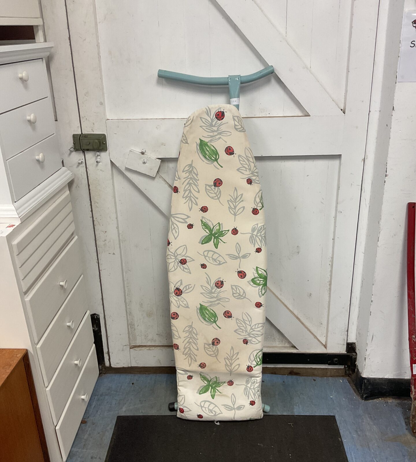 Folding ironing board with ladybug cover