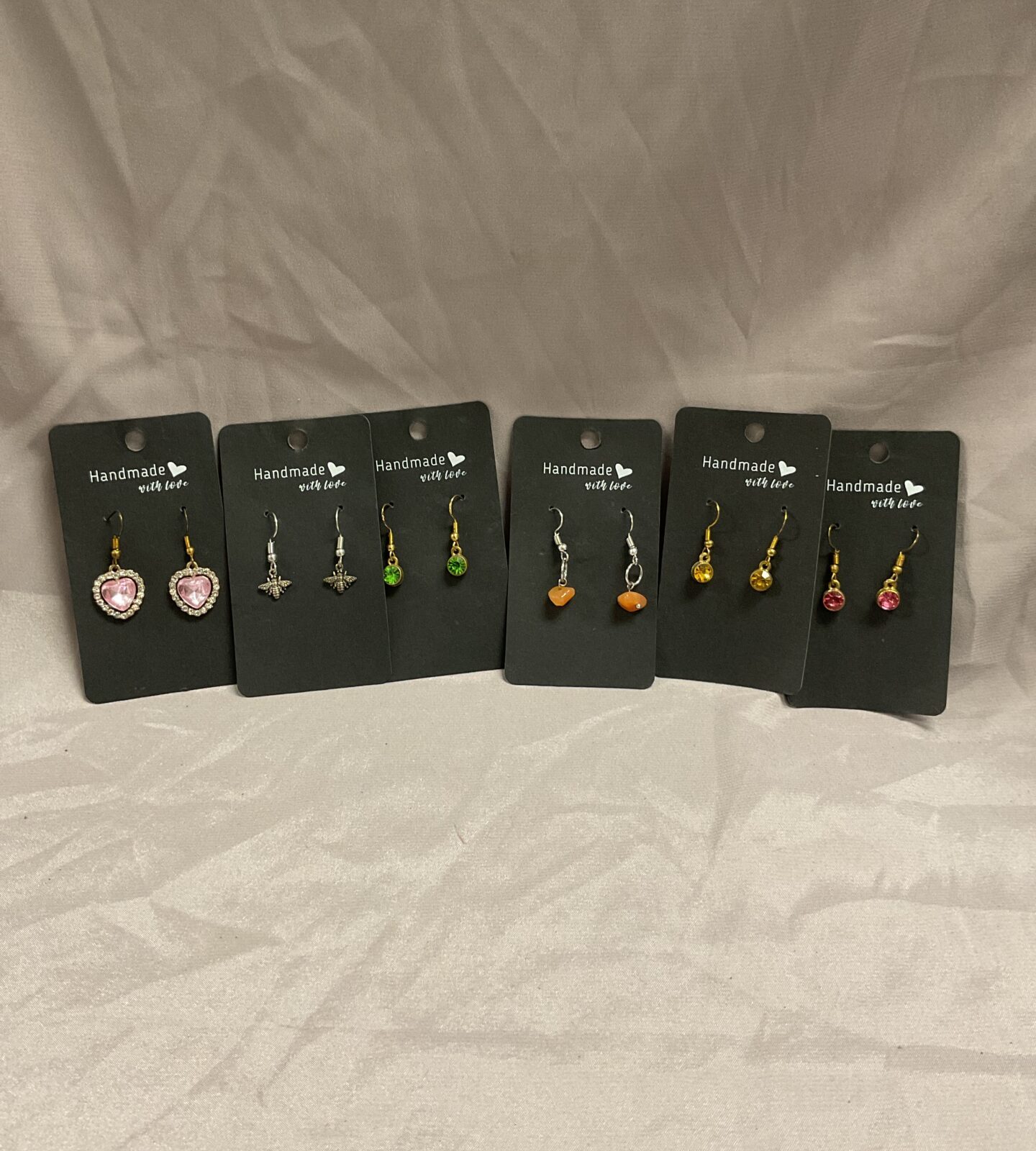 Six pairs of handmade with love earrings