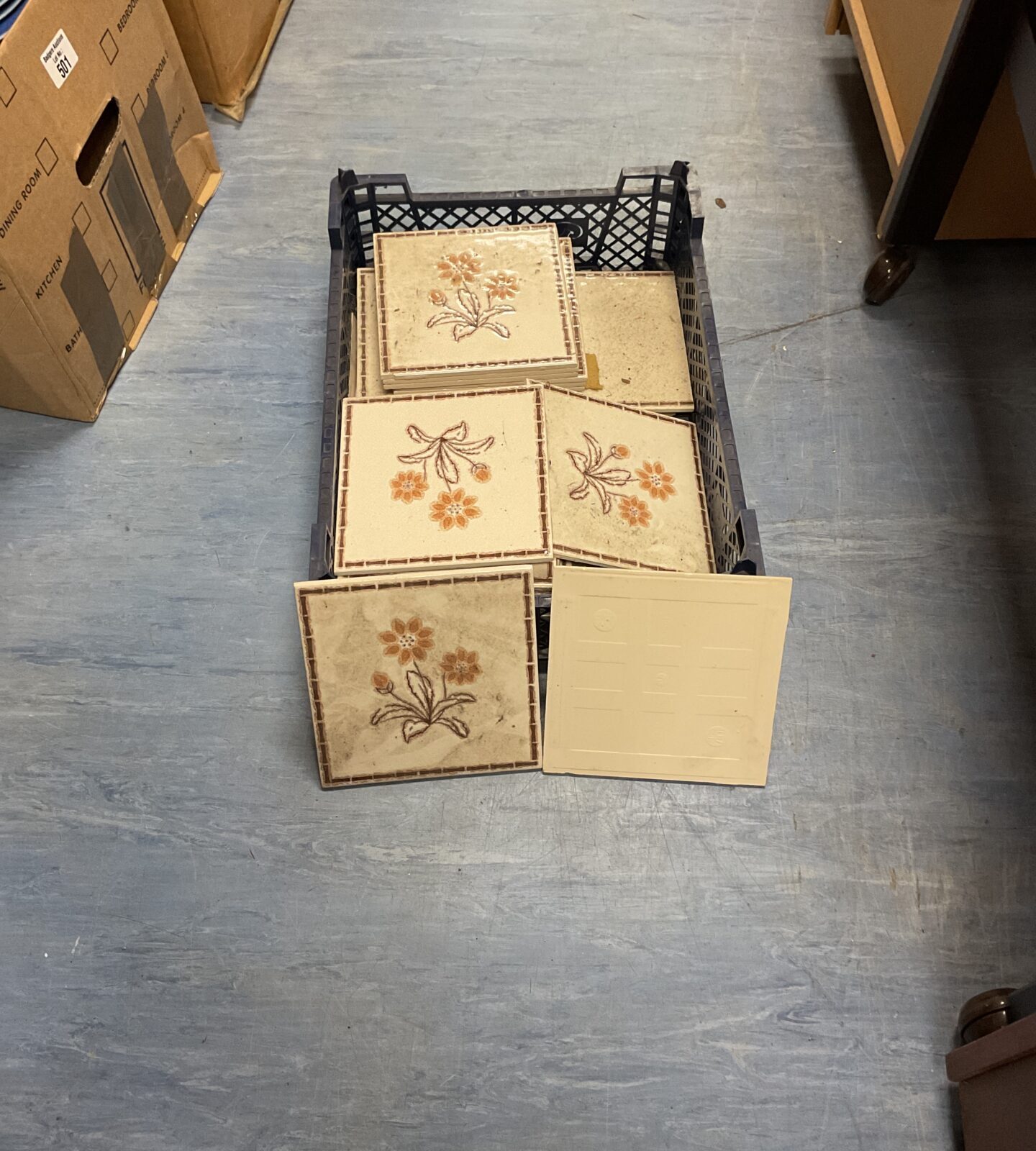 Crate of flower patterned tiles