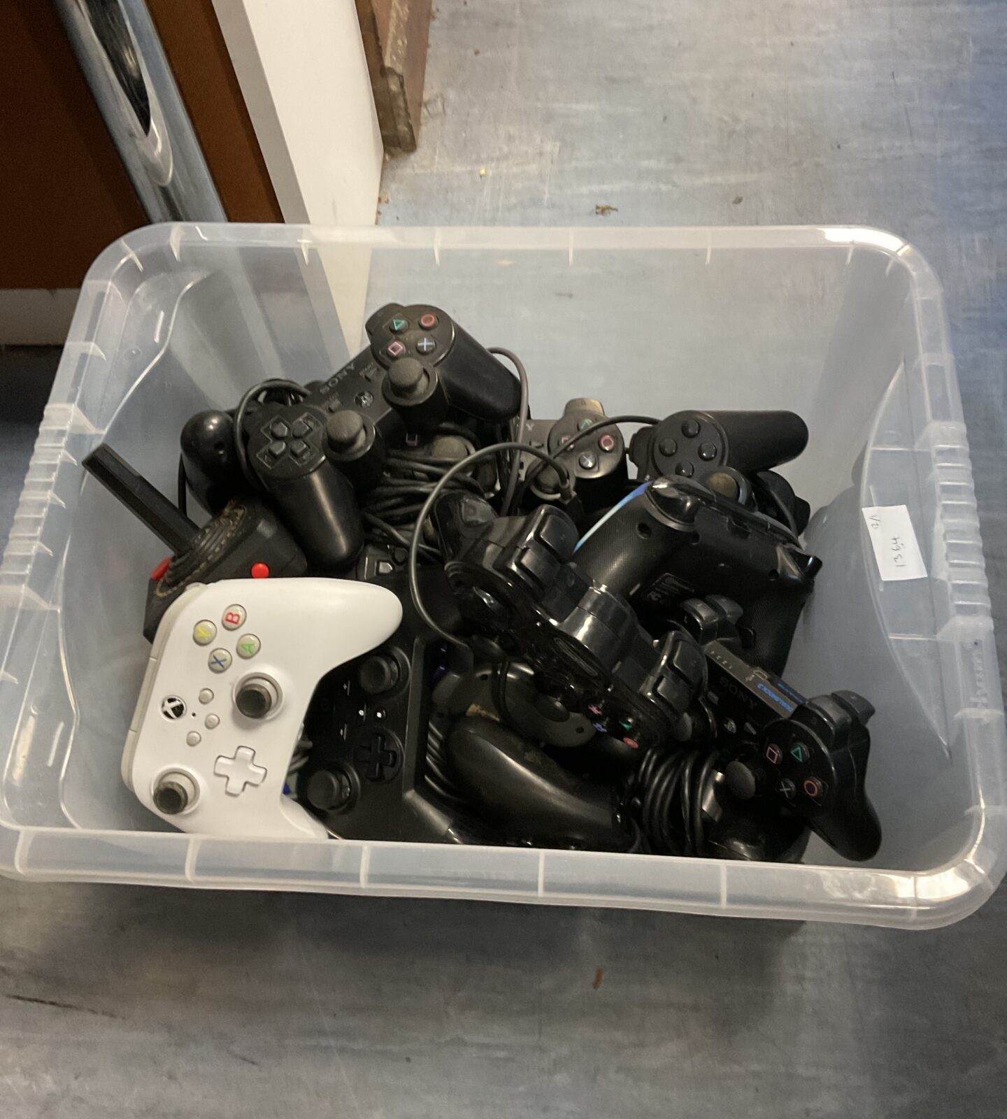 Box of gaming controllers including xbox & PlayStation