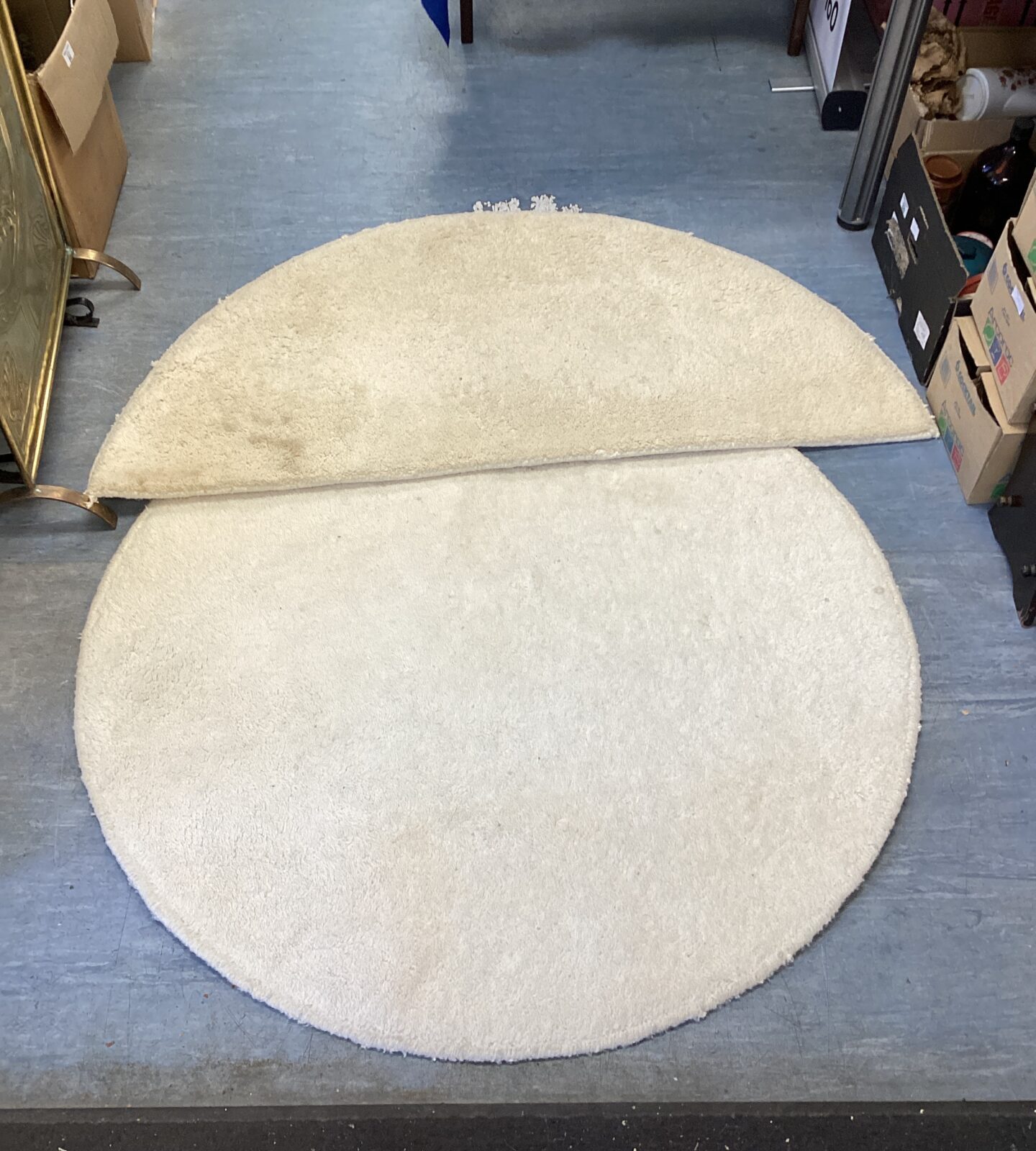 Two cream rugs one circular & one semi circle