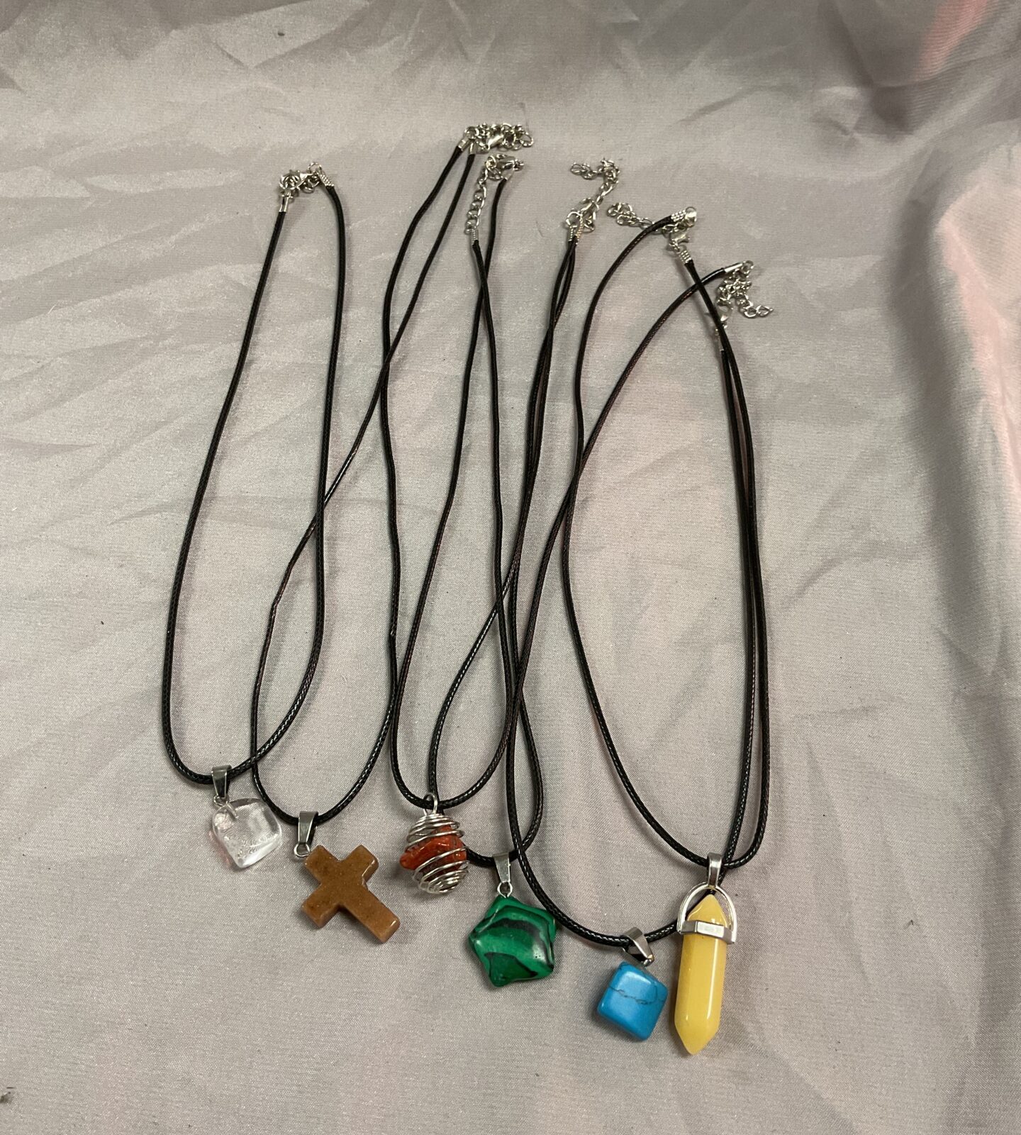 Six polished stone pendant necklaces