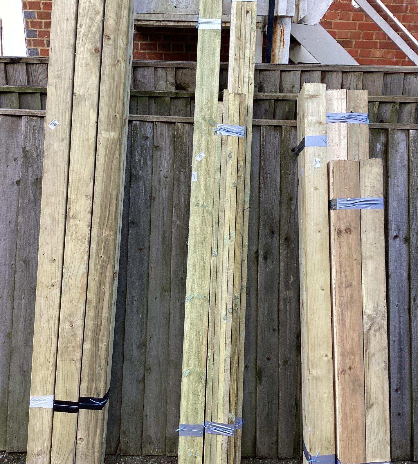 Three bundles of mixed lengths of timber