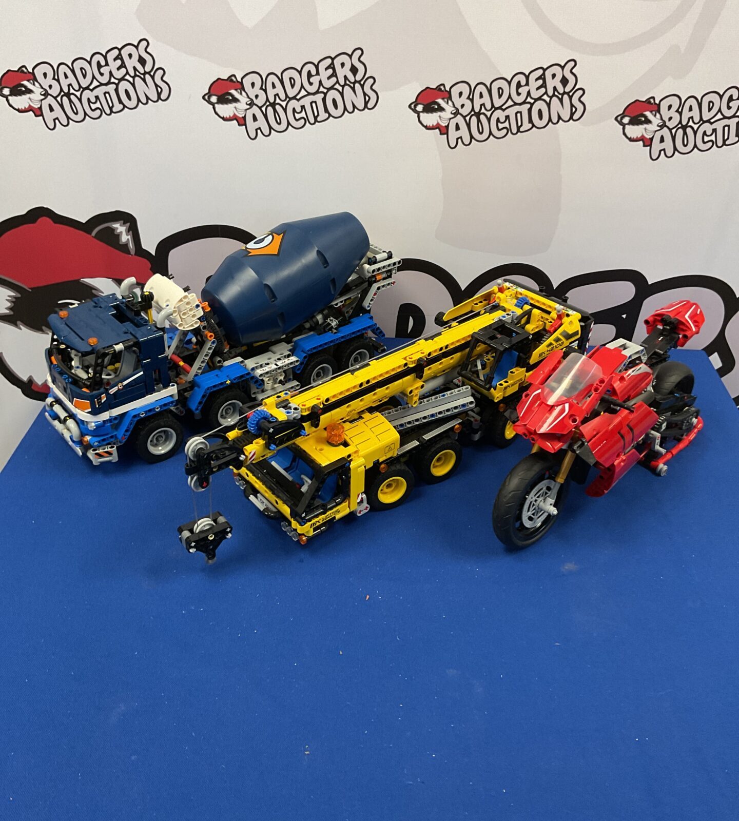 Three Lego technic vehicles inc crane and motorcycle