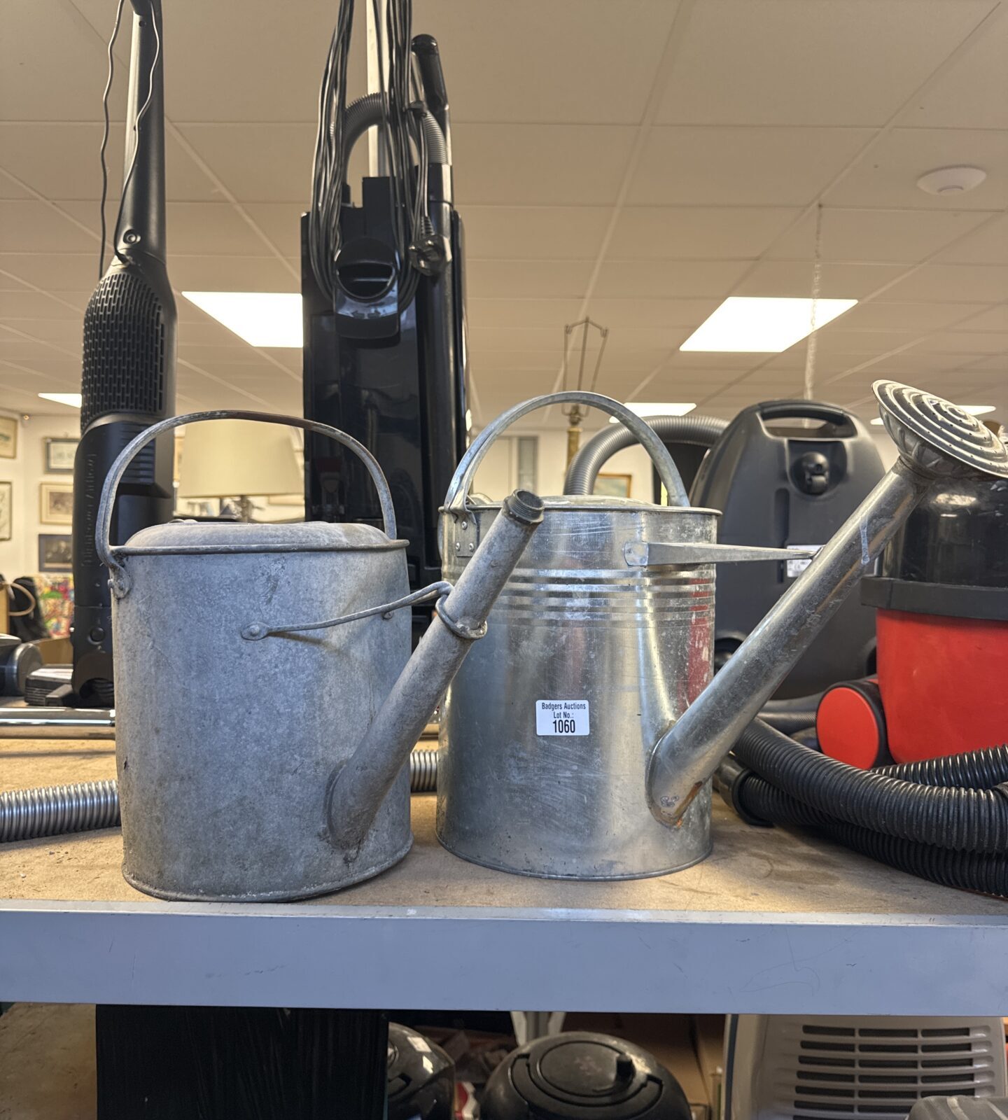 Two galvanised watering cans