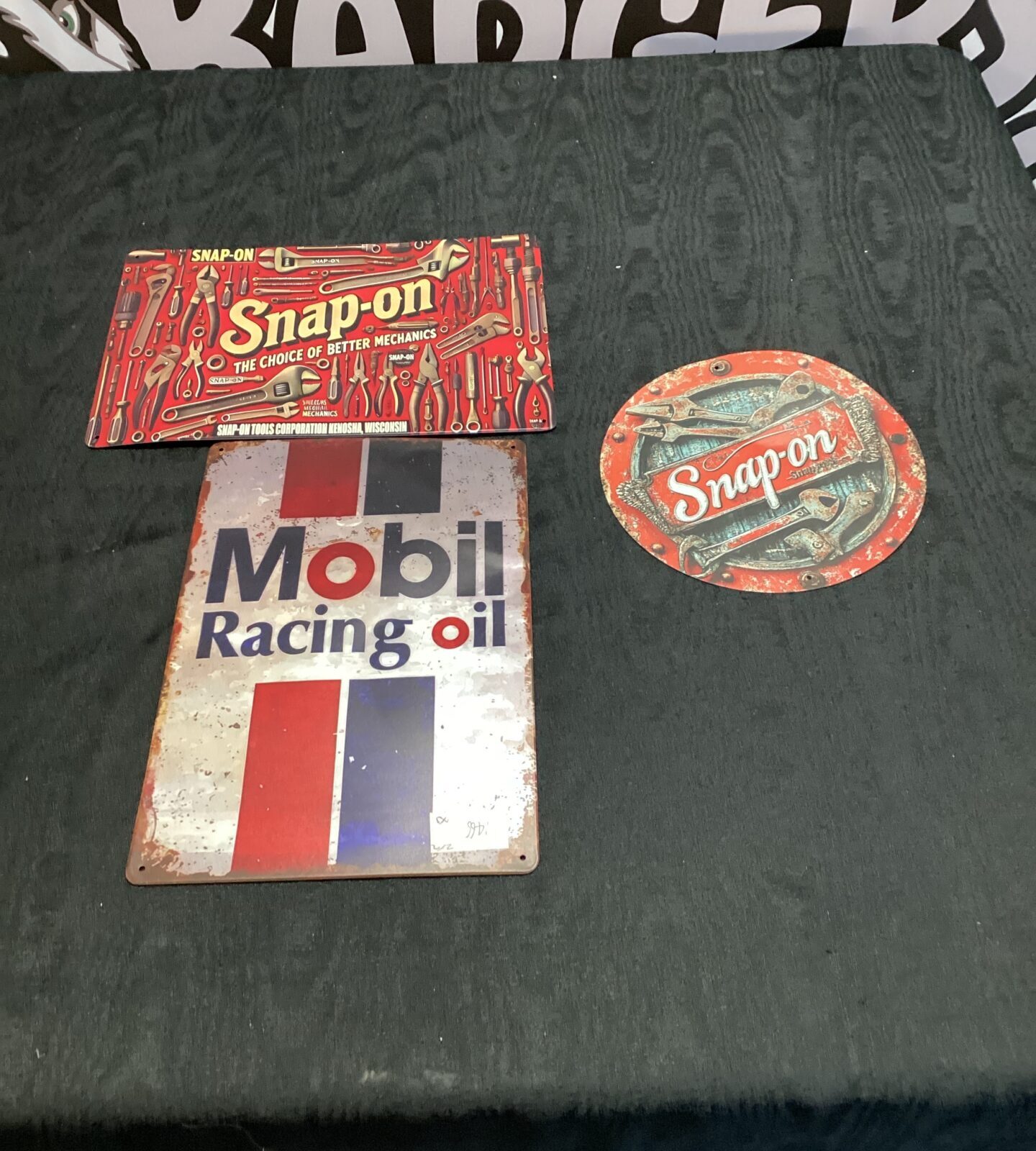 Two tin Snap on tools signs with mobil racing oil tin sign