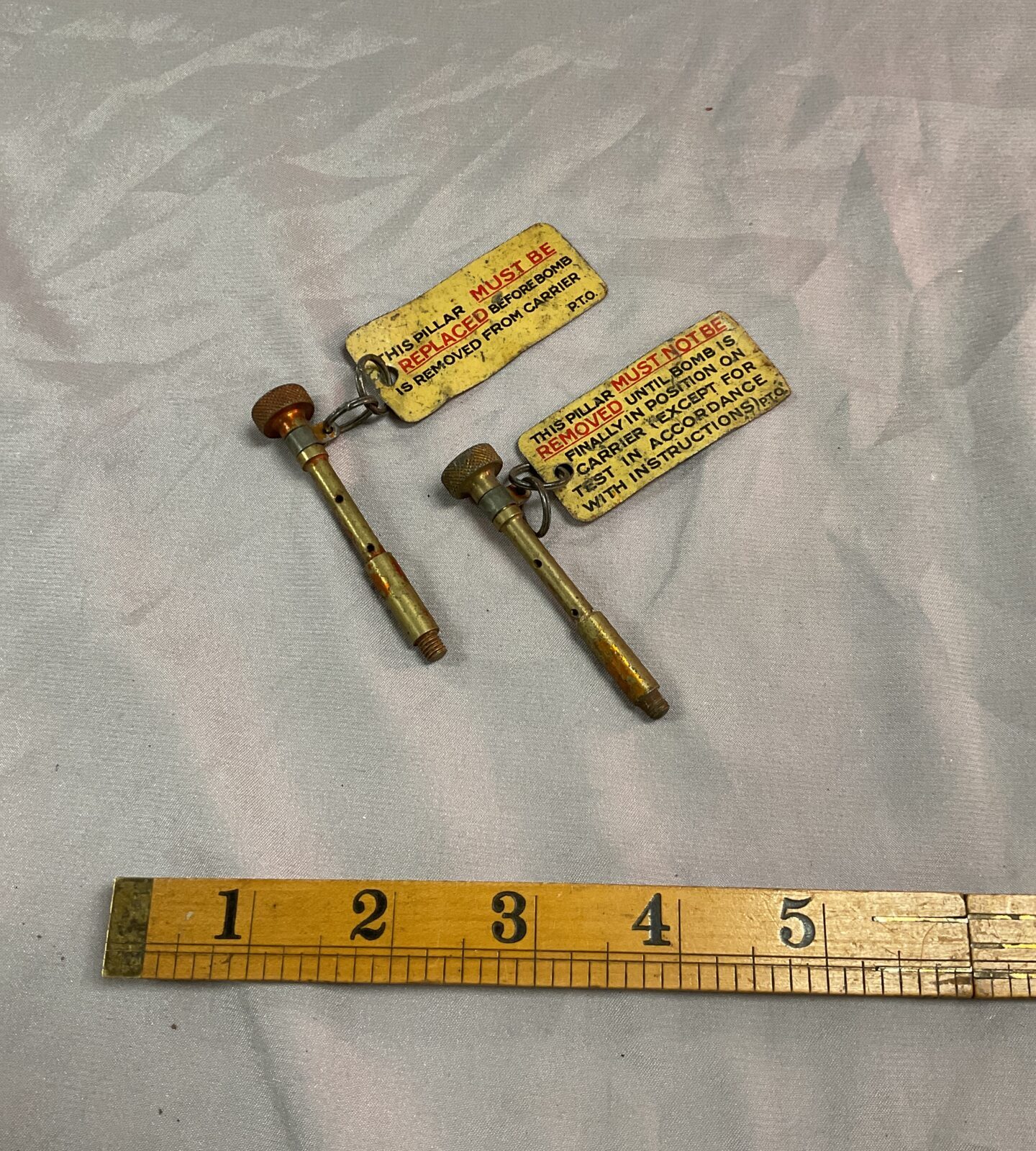 Two Ww2 bomb retaining pins with tags