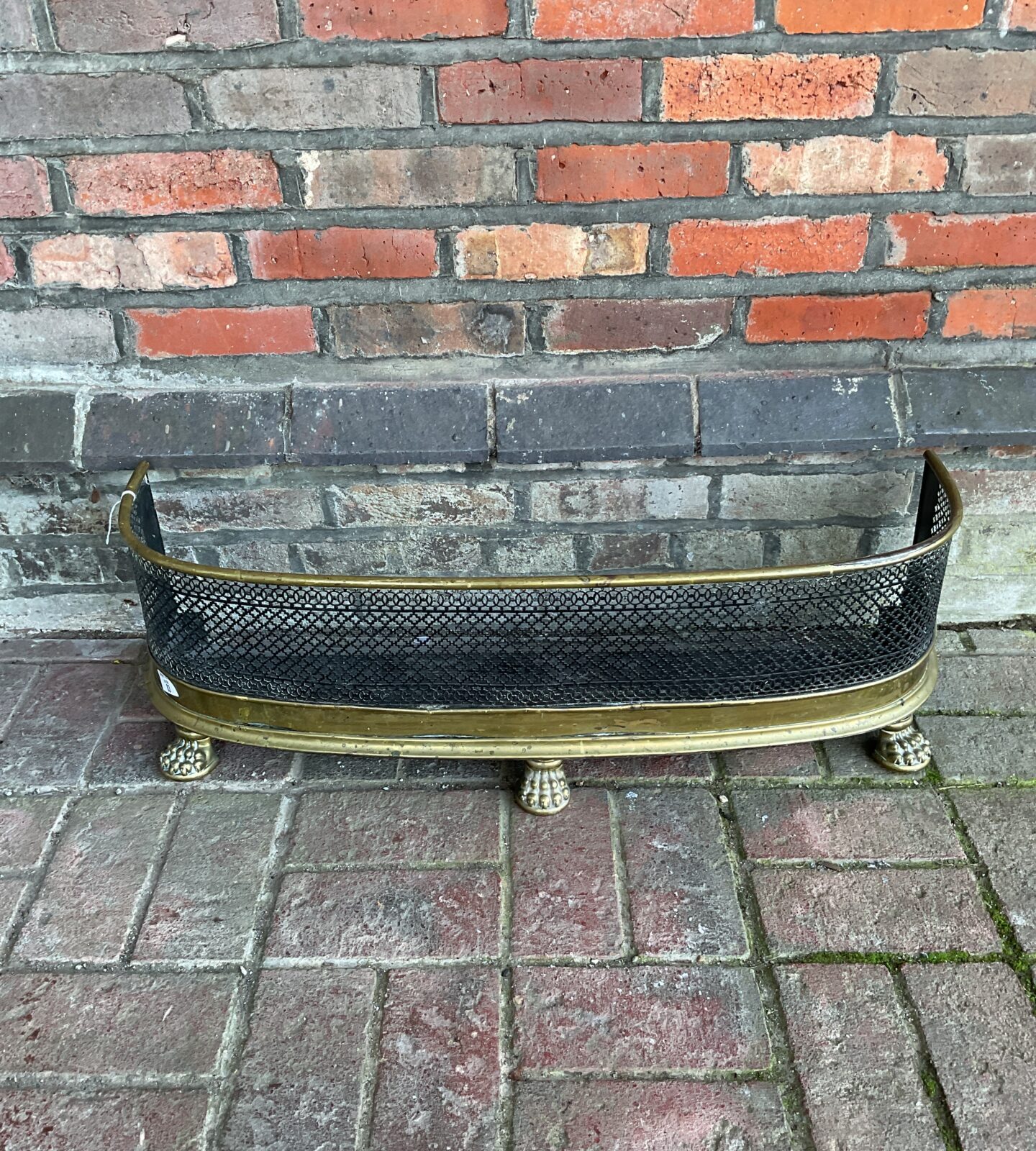 Victorian brass fireplace fender with clawed feet