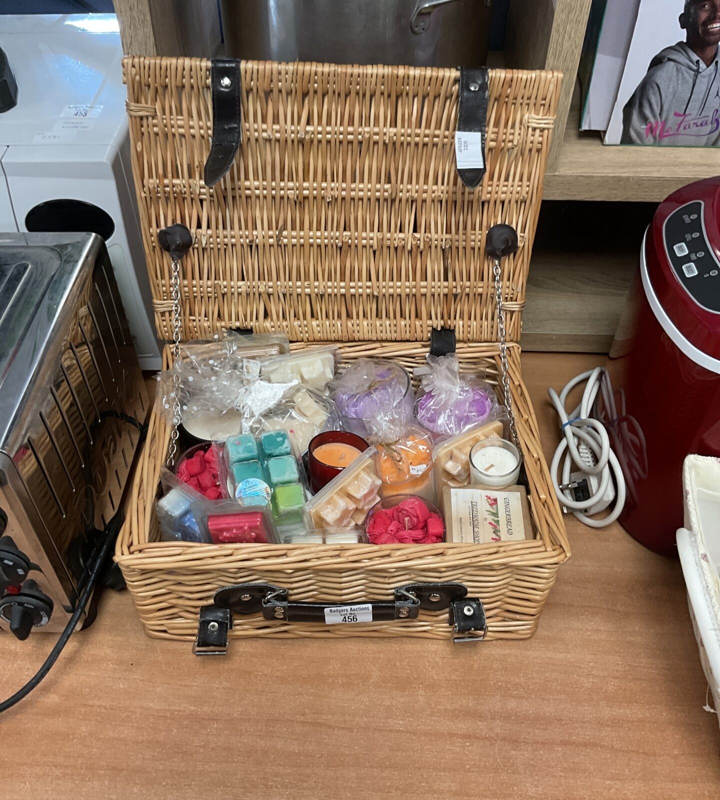 Wicker basket containing candles and wax melts