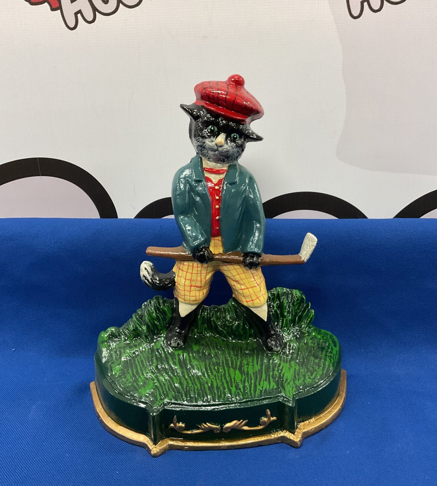 Cast iron golfing cat doorstop