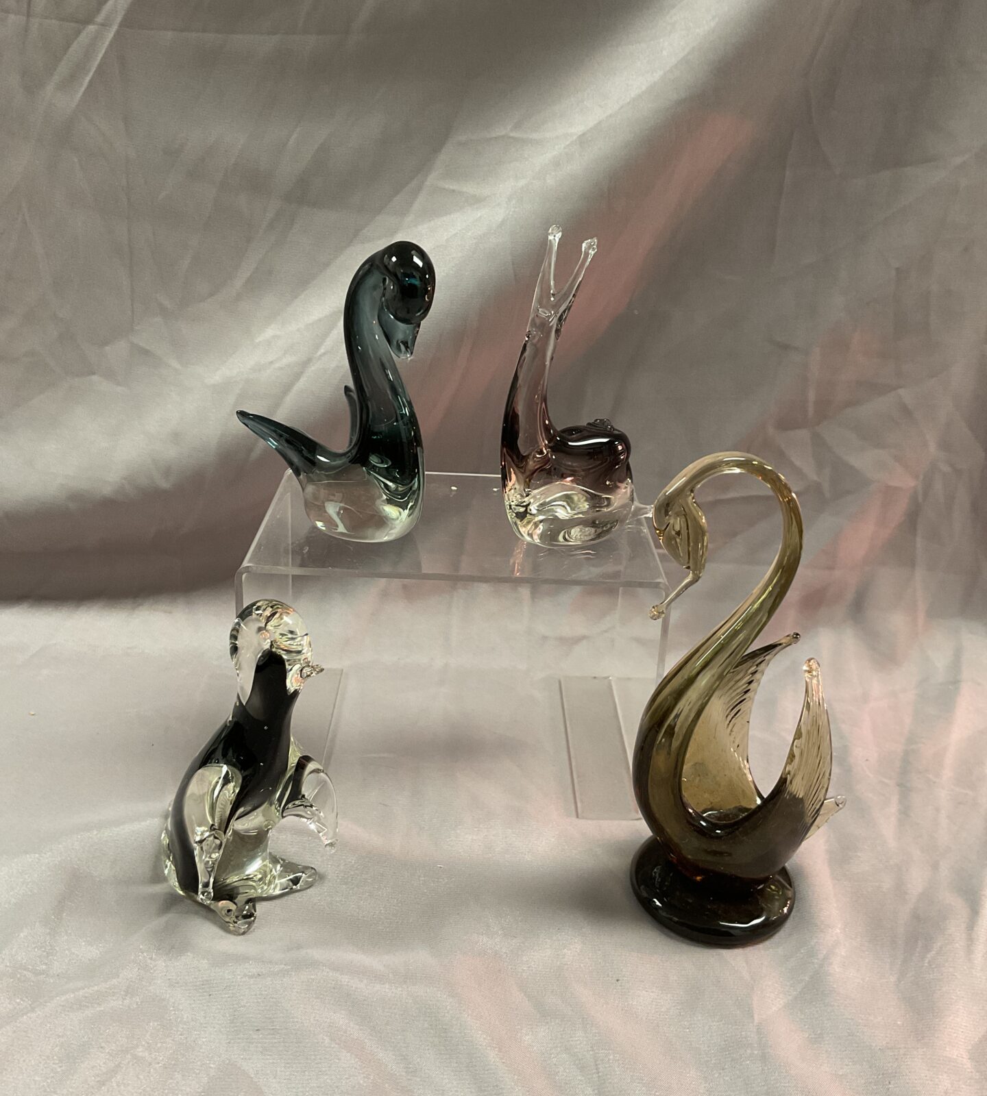 Two glass swans a penguin and snail