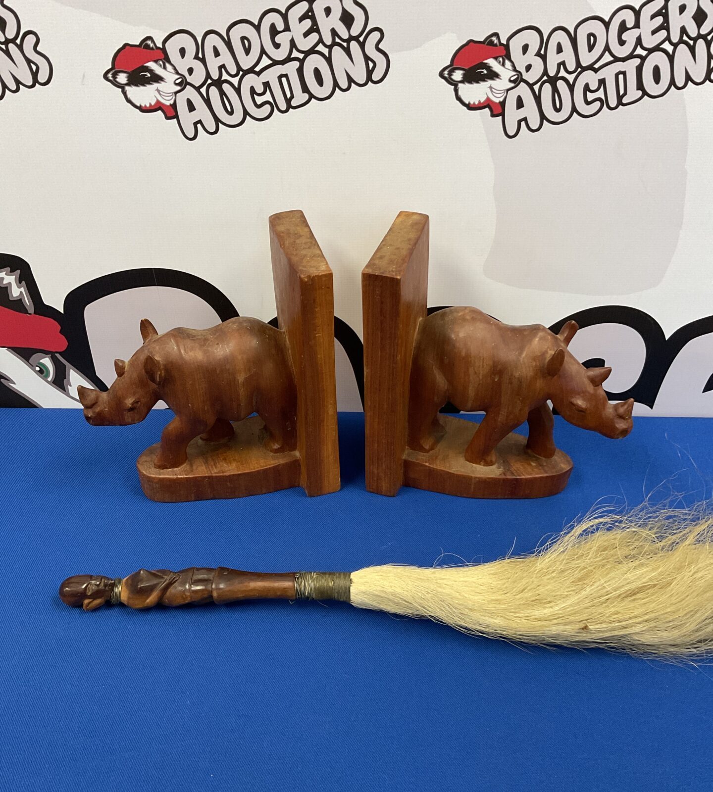 Pair of carved wooden rhino bookends & African fly swatter