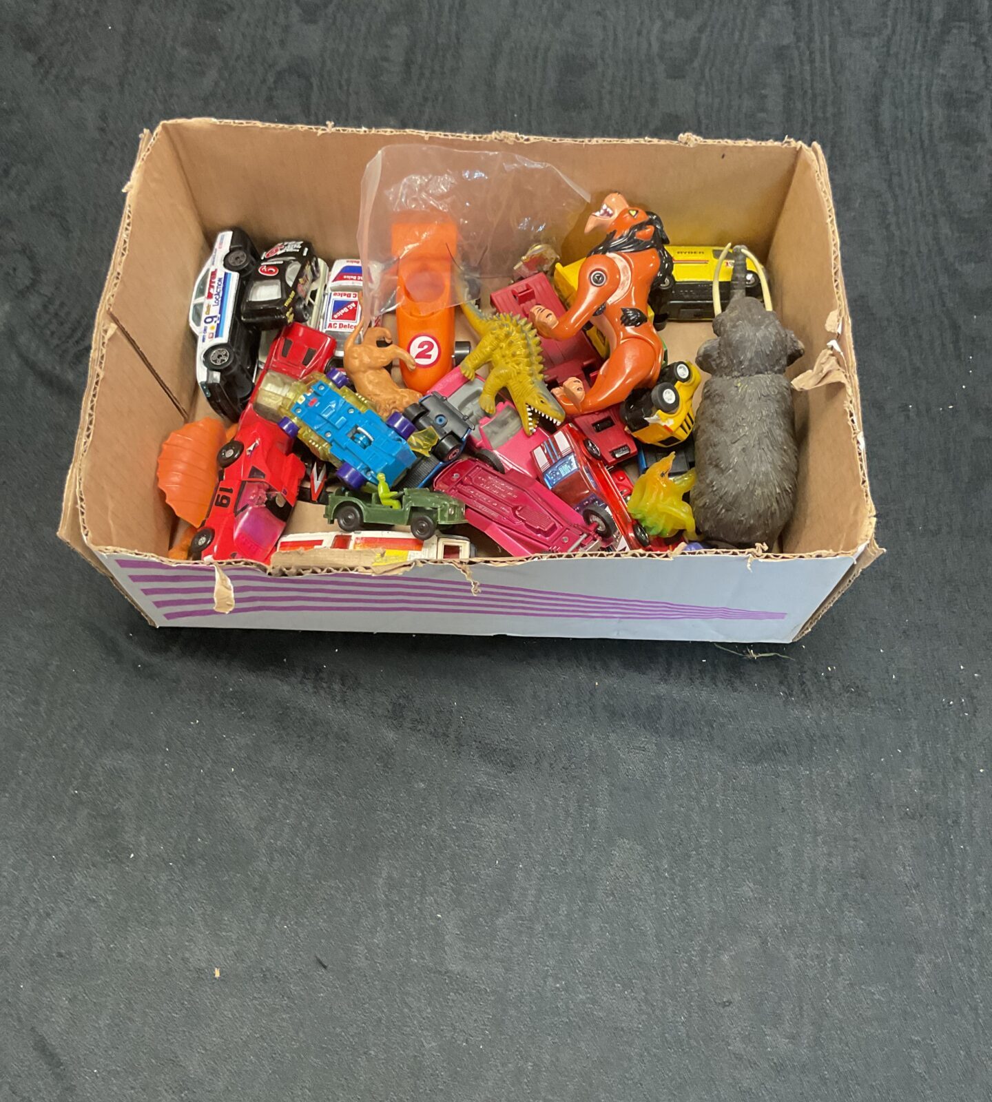 Box of mixed plastic animal toys and diecasts inc corgi, matchbox and burago