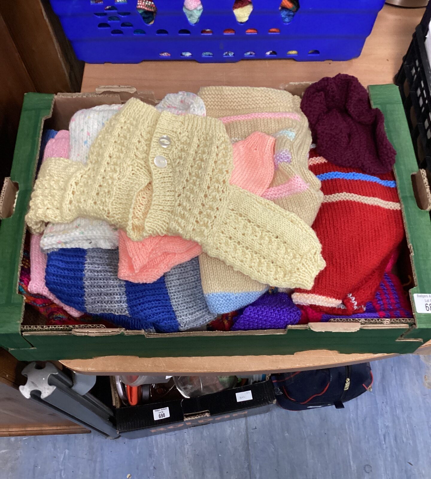 Tray of knitted cardigans