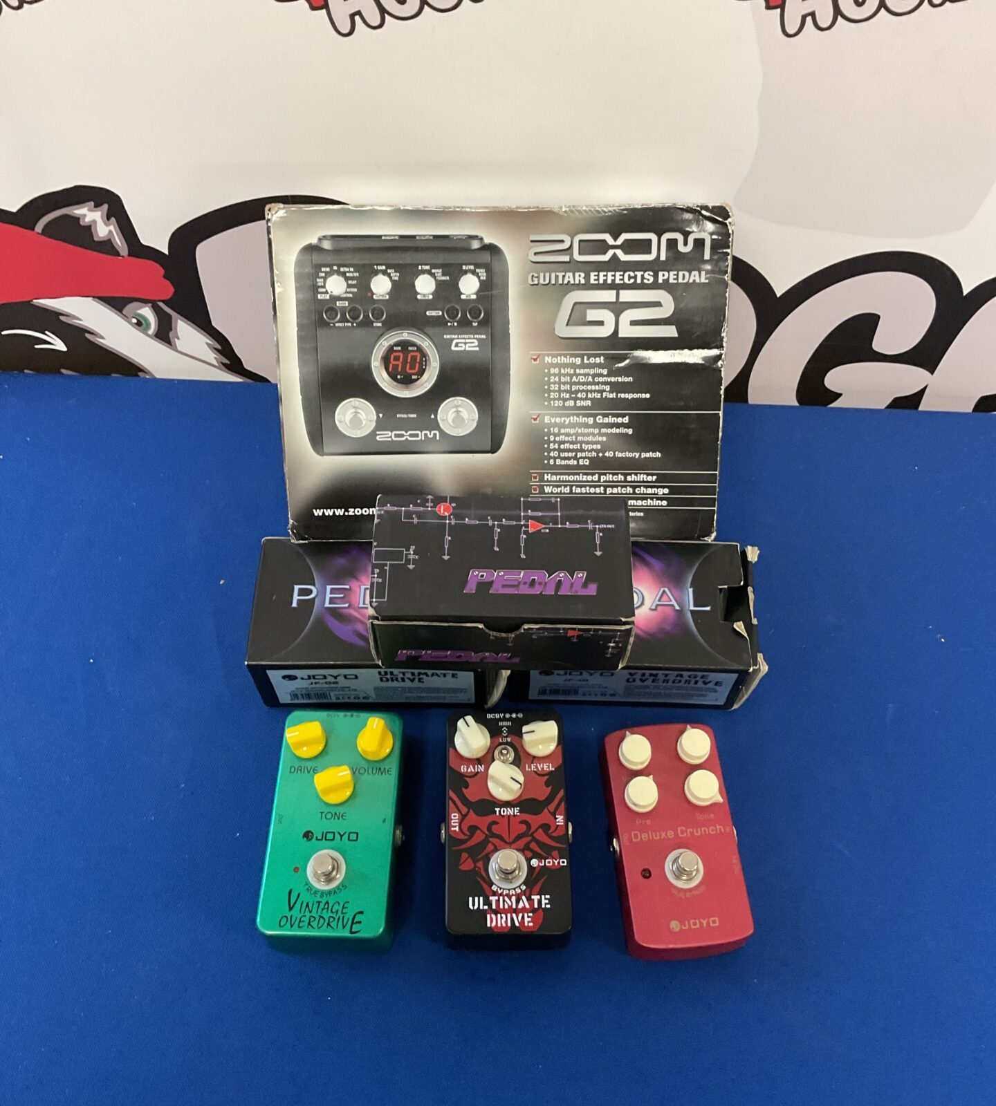 Four guitar effect pedals including zoom g2 & joyo