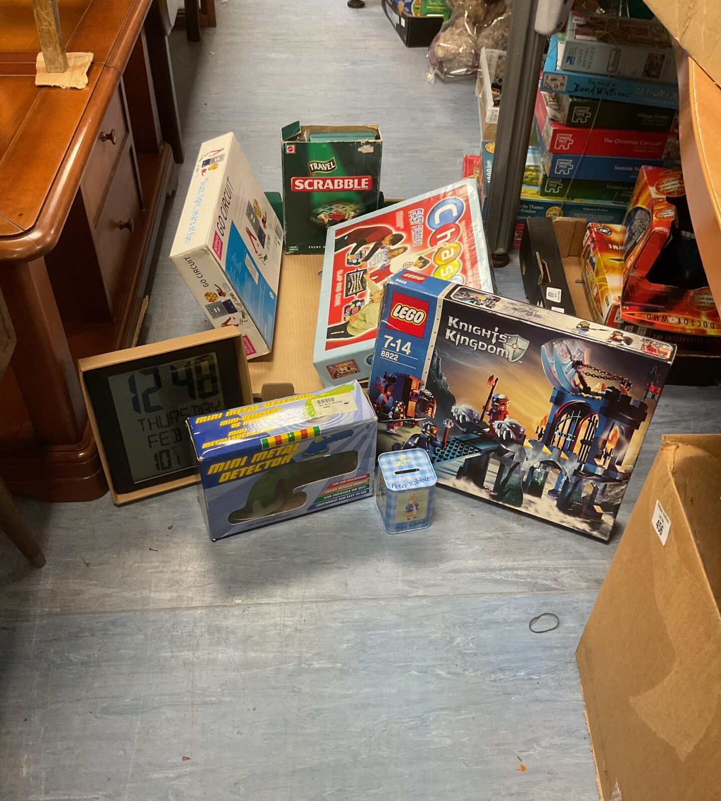 Box of mixed toys inc scrabble, Lego knight set, alarm clock and peter rabbit tin money box