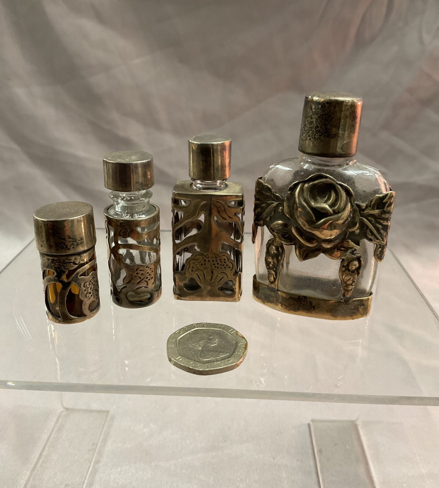 Four hallmarked silver mounted perfume bottles