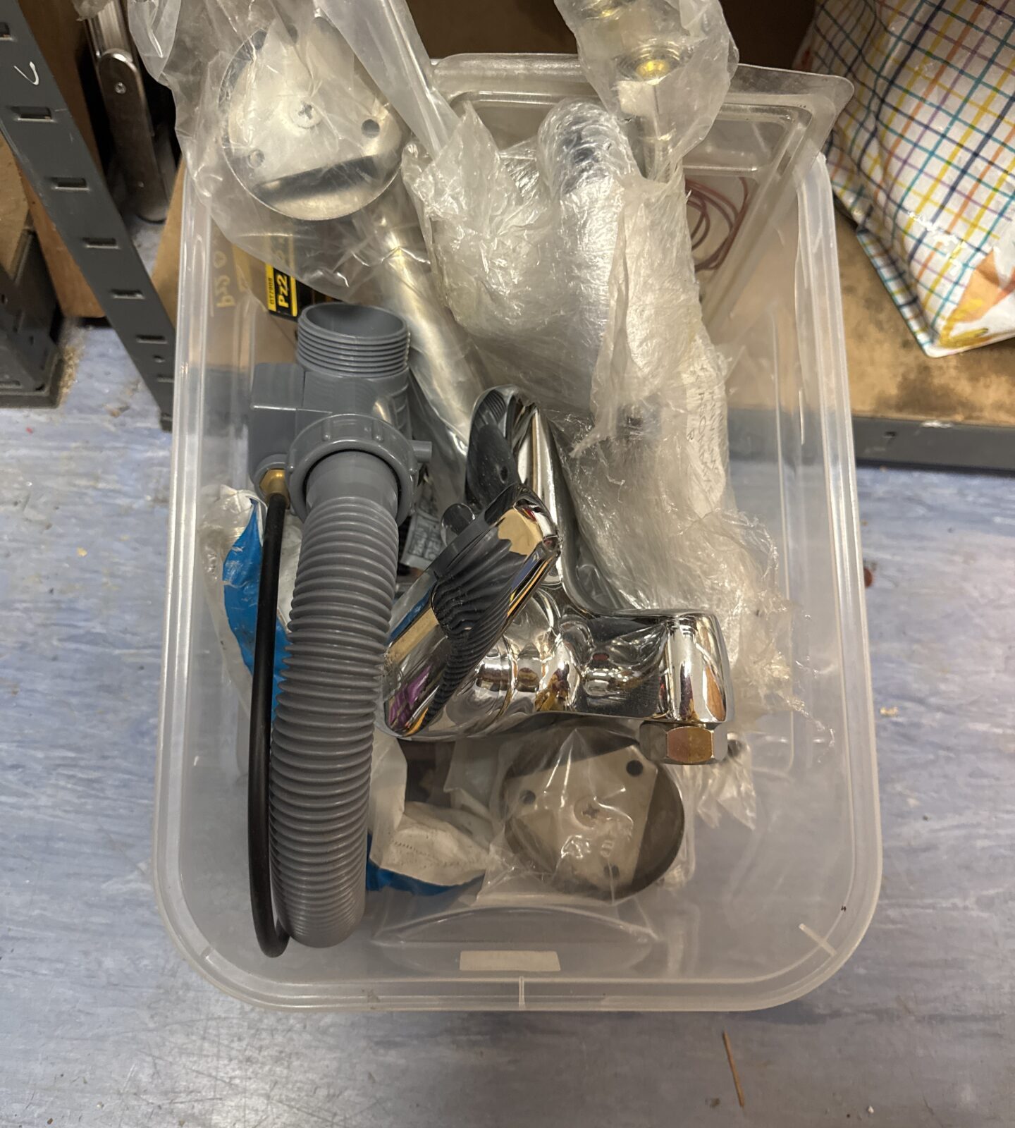 Box of plumbing items inc a trap, shower mixer tap & others