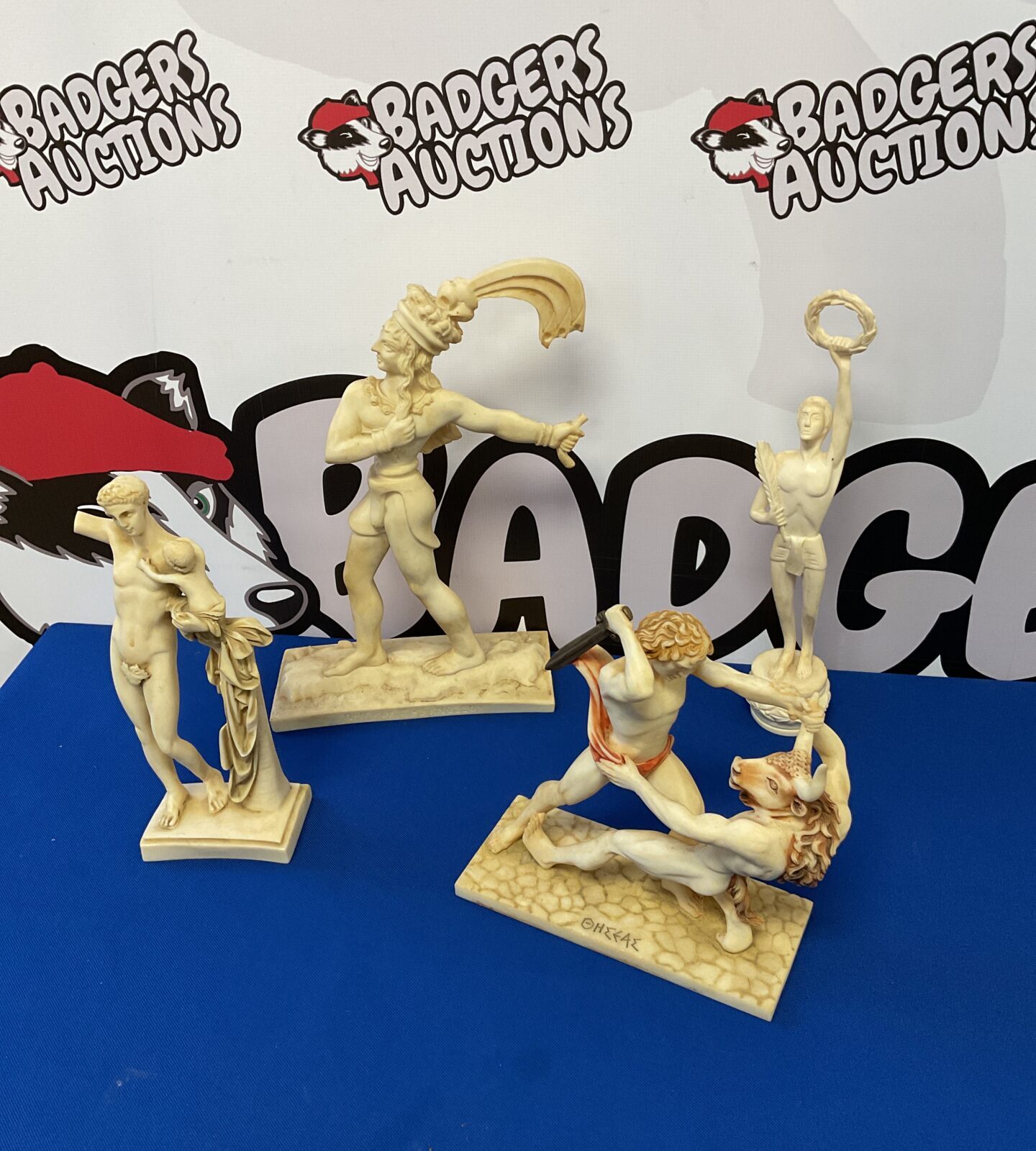 Four grecian god resin sculptures including minotaur