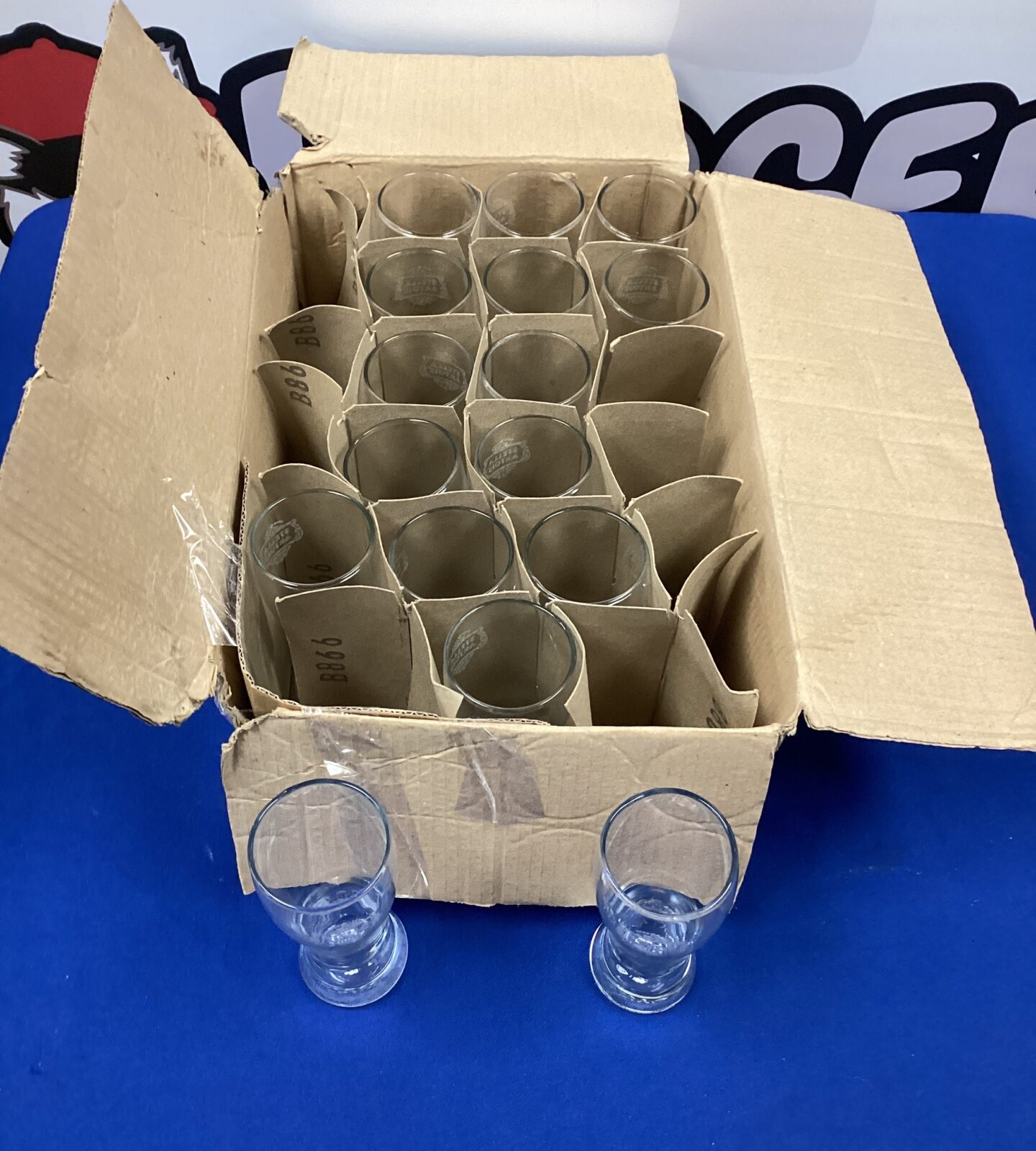 Box of sixteen stella half pint glasses