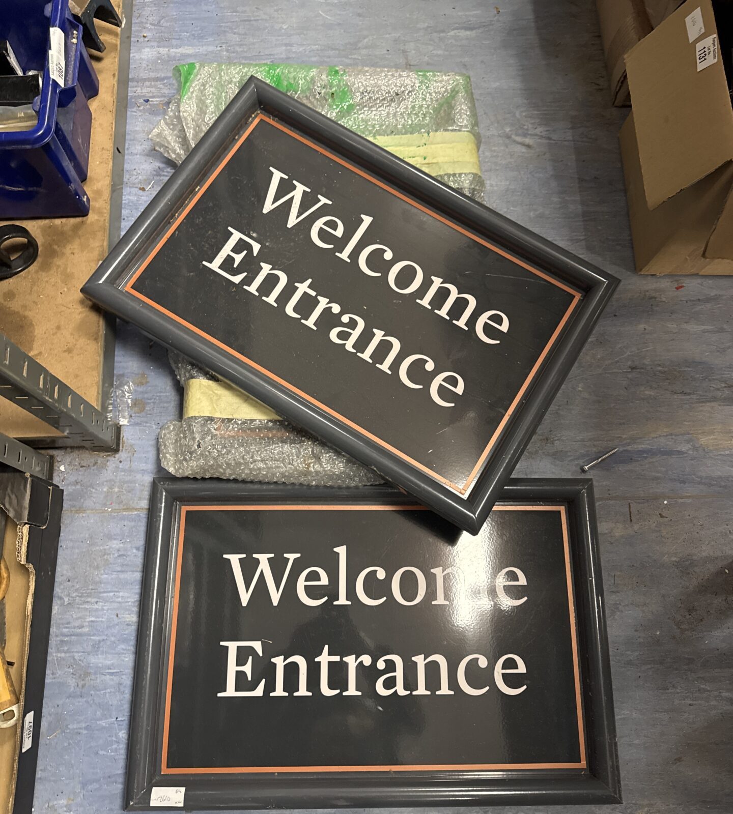 Four welcome entrance metal signs 23.5” length - one has paint peeling from bottom corner